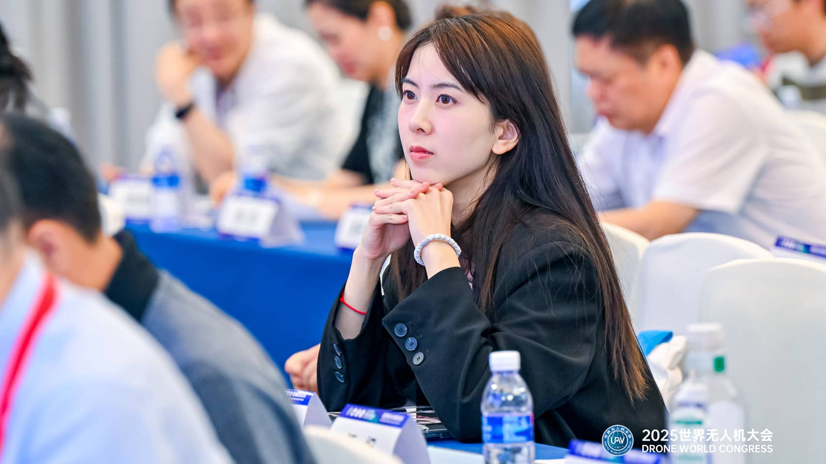Delegates listen at a forum table during the drone congress in Shenzhen.