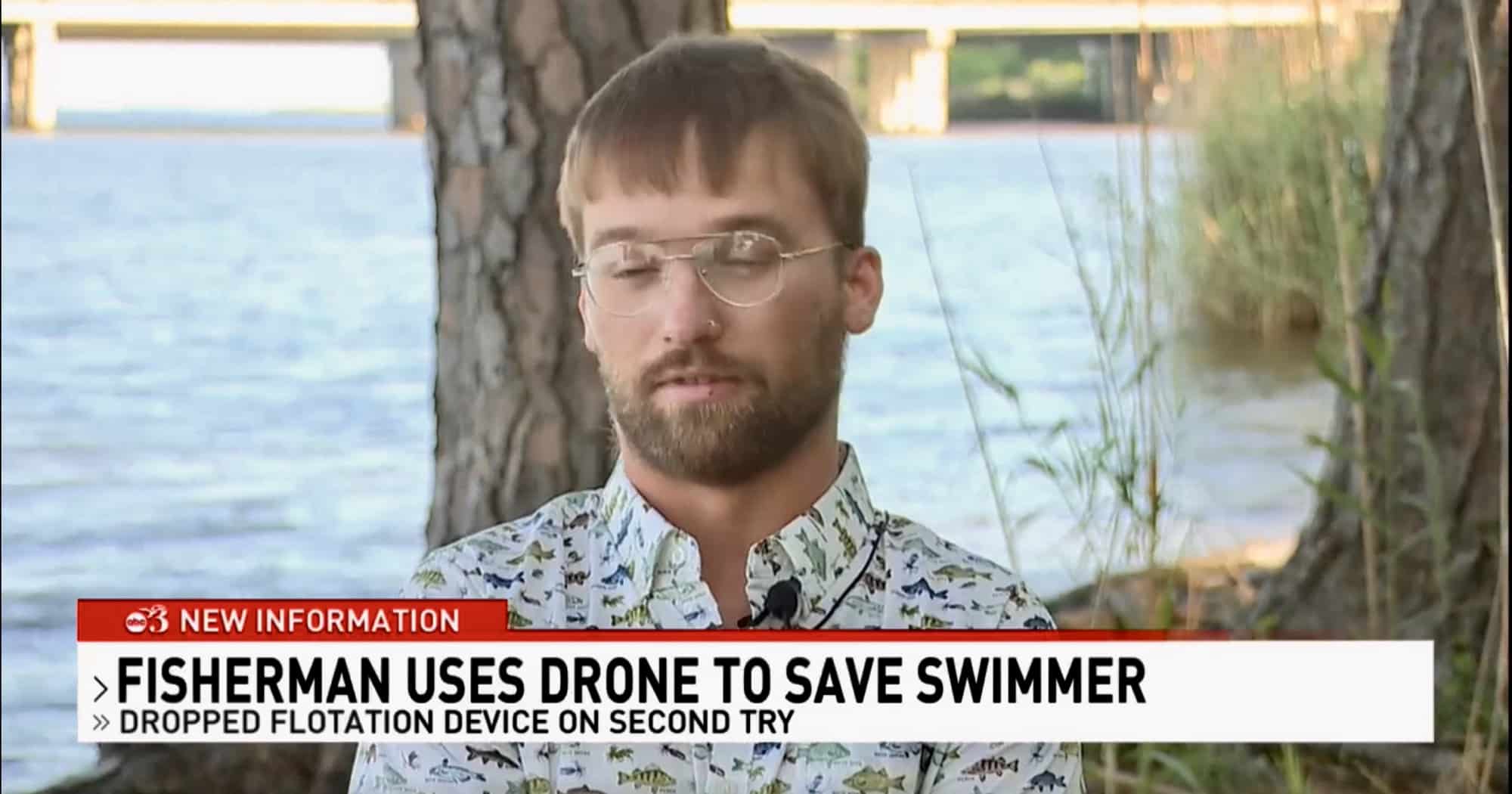 Television interview with a man beside a caption about a drone saving a swimmer.