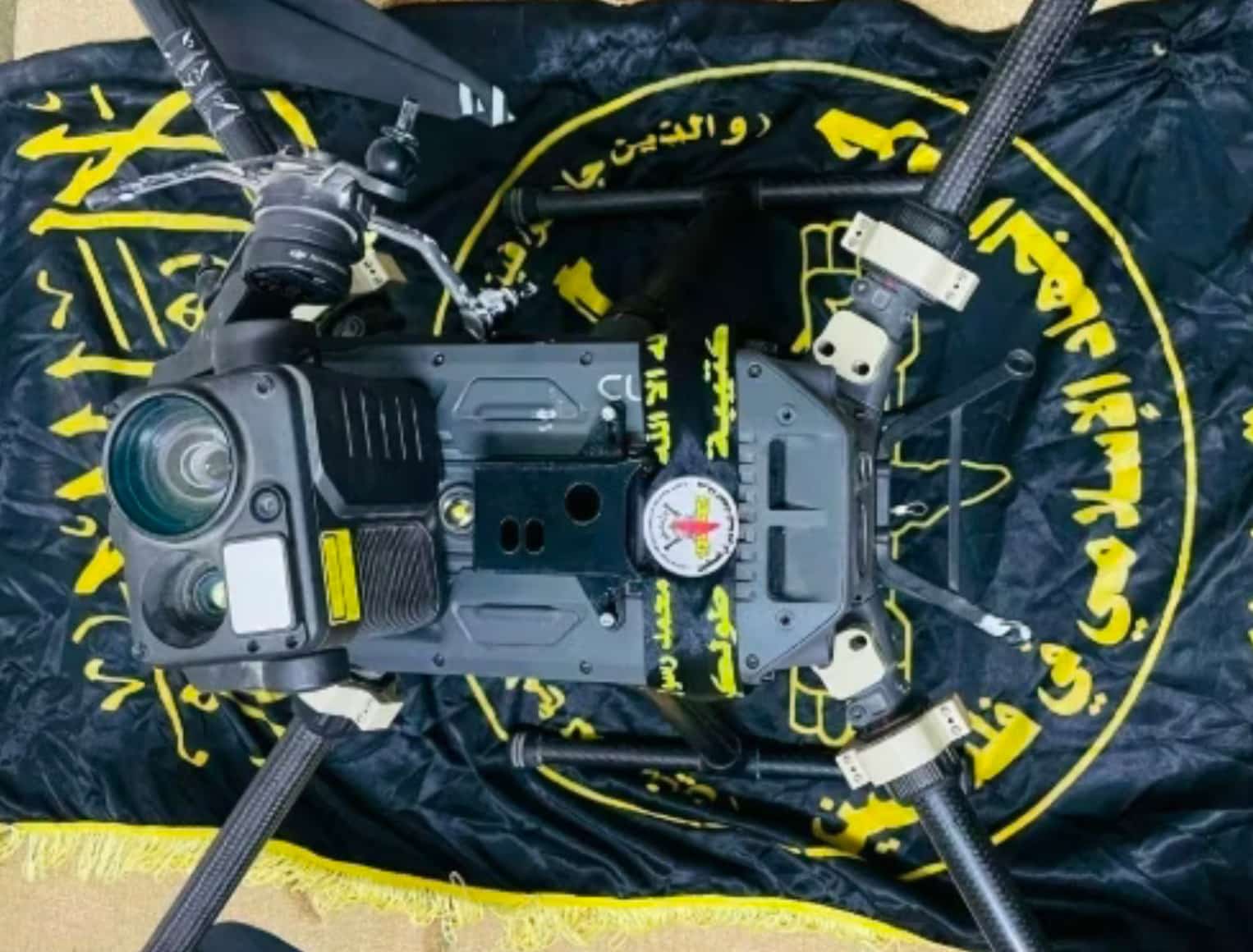 A captured enterprise quadcopter laid out on the same black and yellow banner.