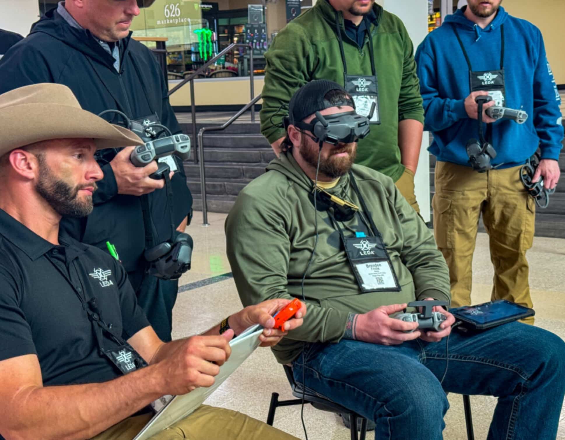 Public safety trainees seated with drone controllers and headsets during a class.
