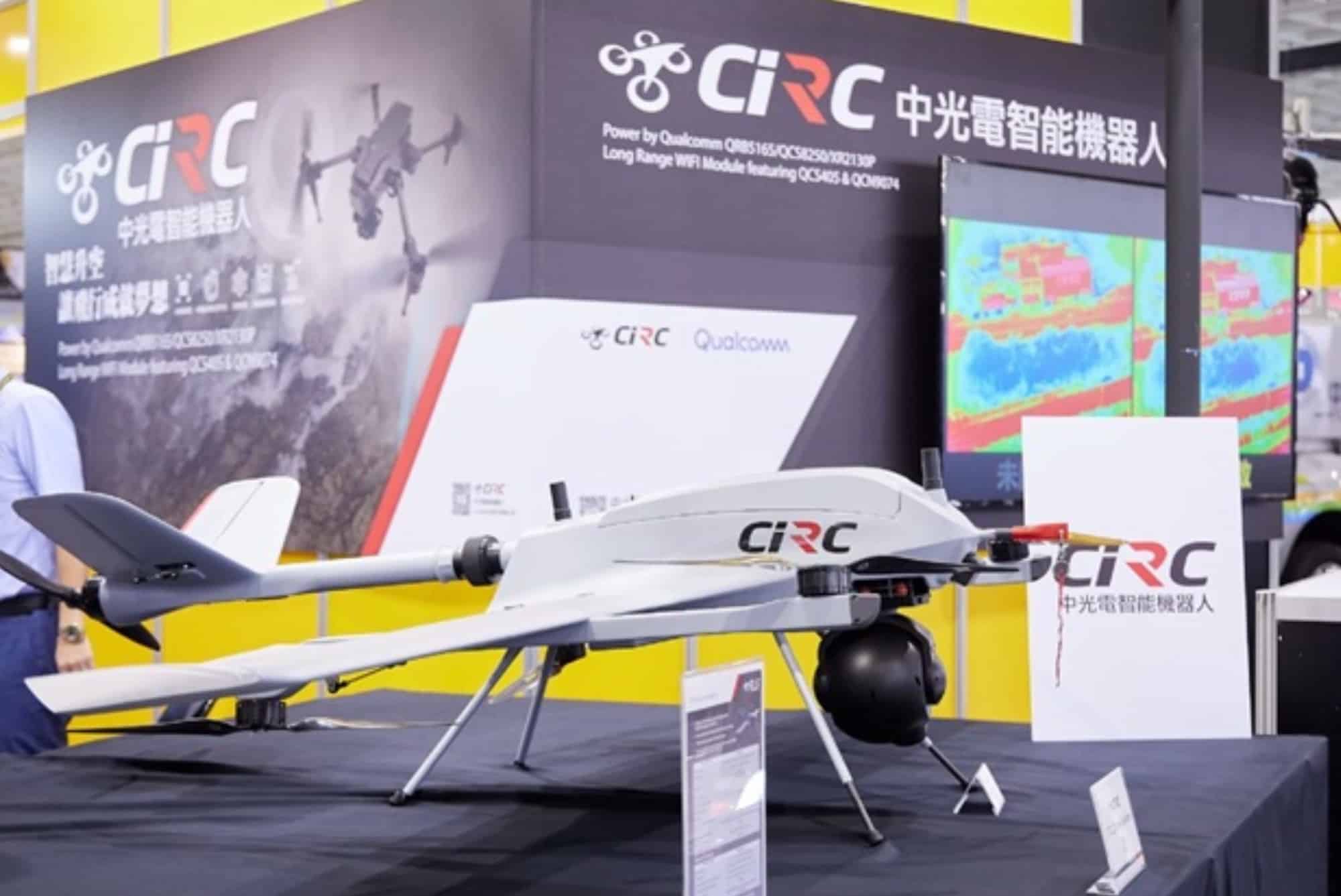 Long-range fixed-wing UAV on display at a CIRC stand with radar imagery behind.