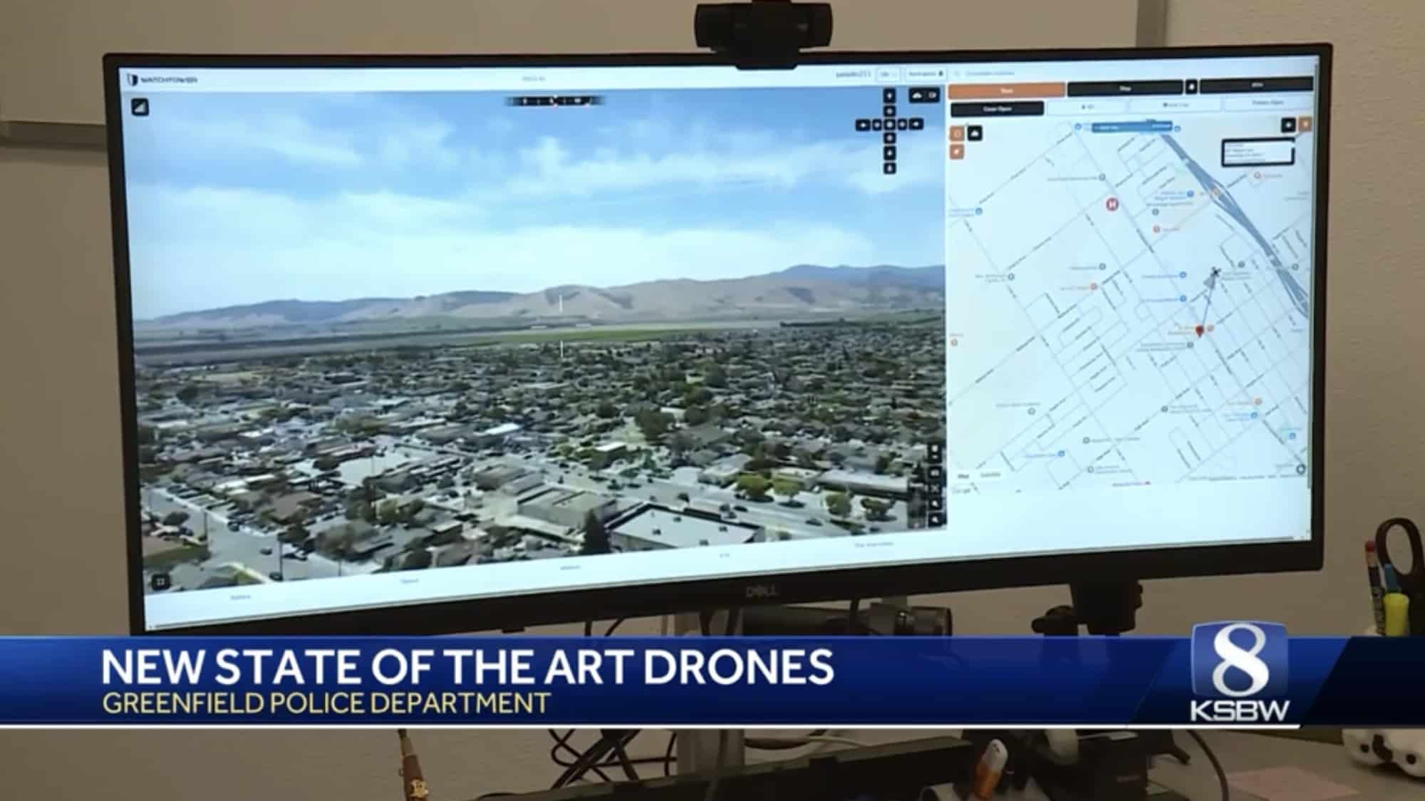 Monitor shows the police drone live aerial feed beside a street map.