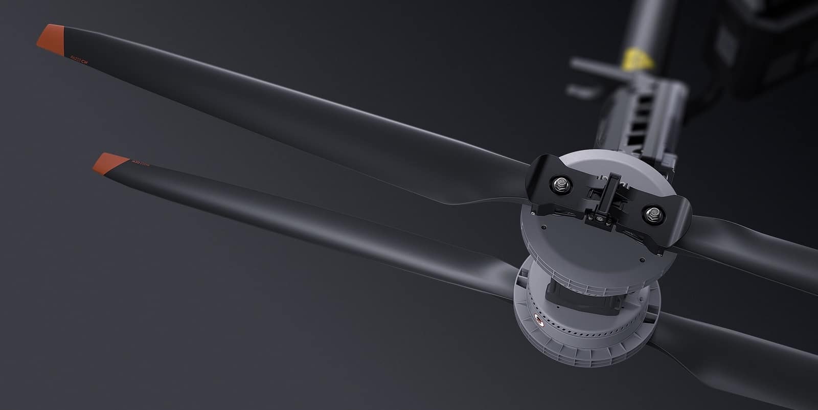 Orange-tipped carbon fiber blades folded around the rotor hub in a product render.