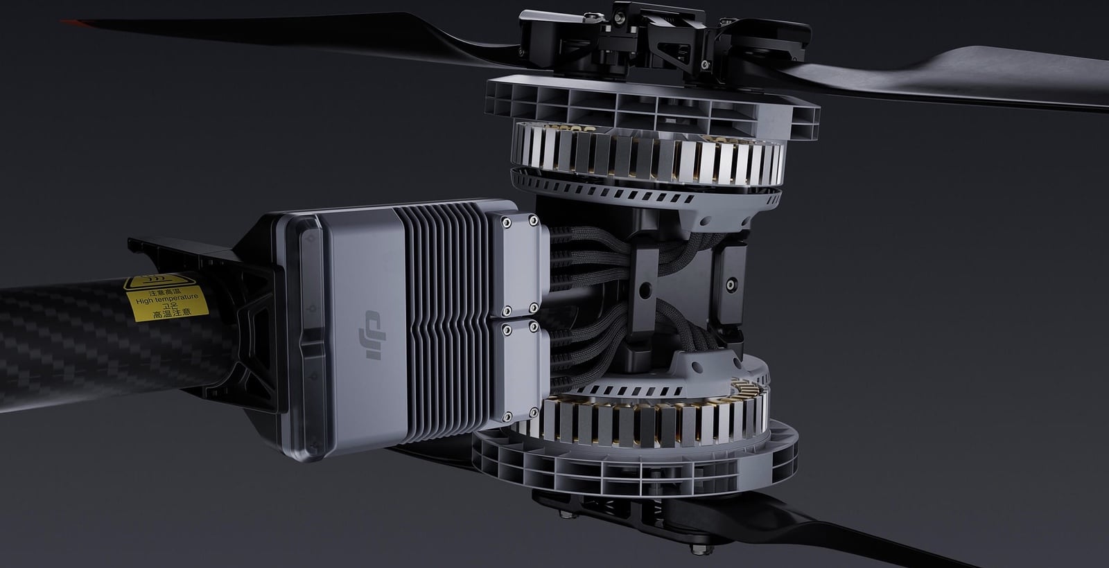 Coaxial dual-rotor motor stack with a finned heat sink on a carbon fiber arm.