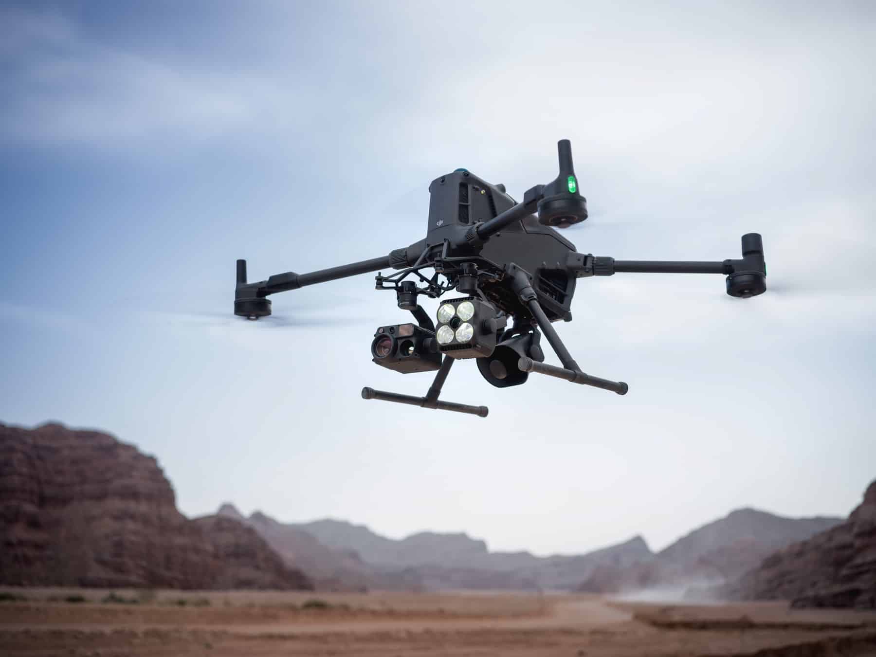Matrice 400 in flight with its multi-sensor payload against red canyon walls.