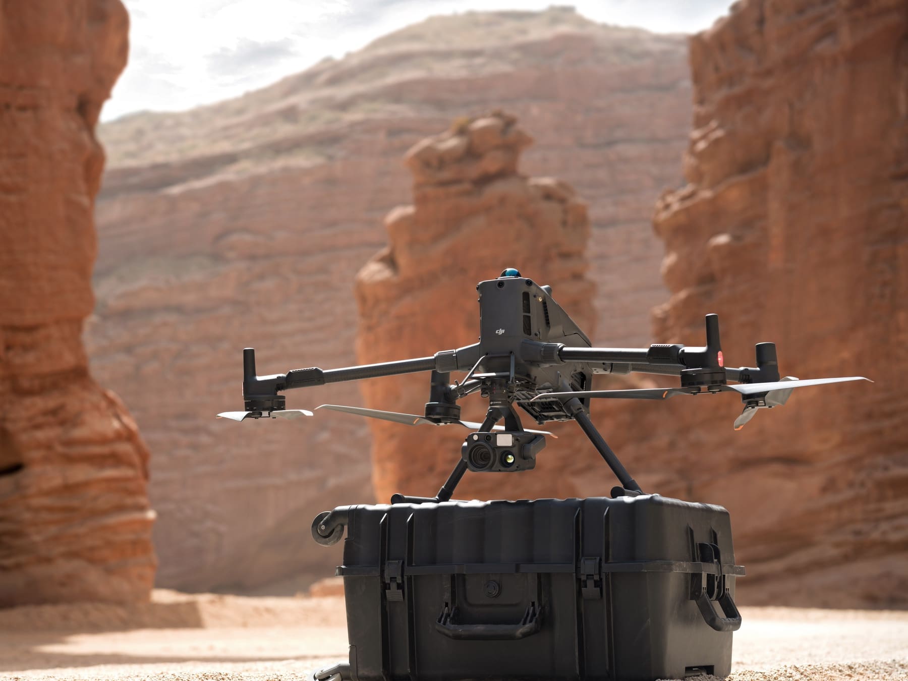 Matrice 400 sits on top of its hard transport case in a desert canyon.