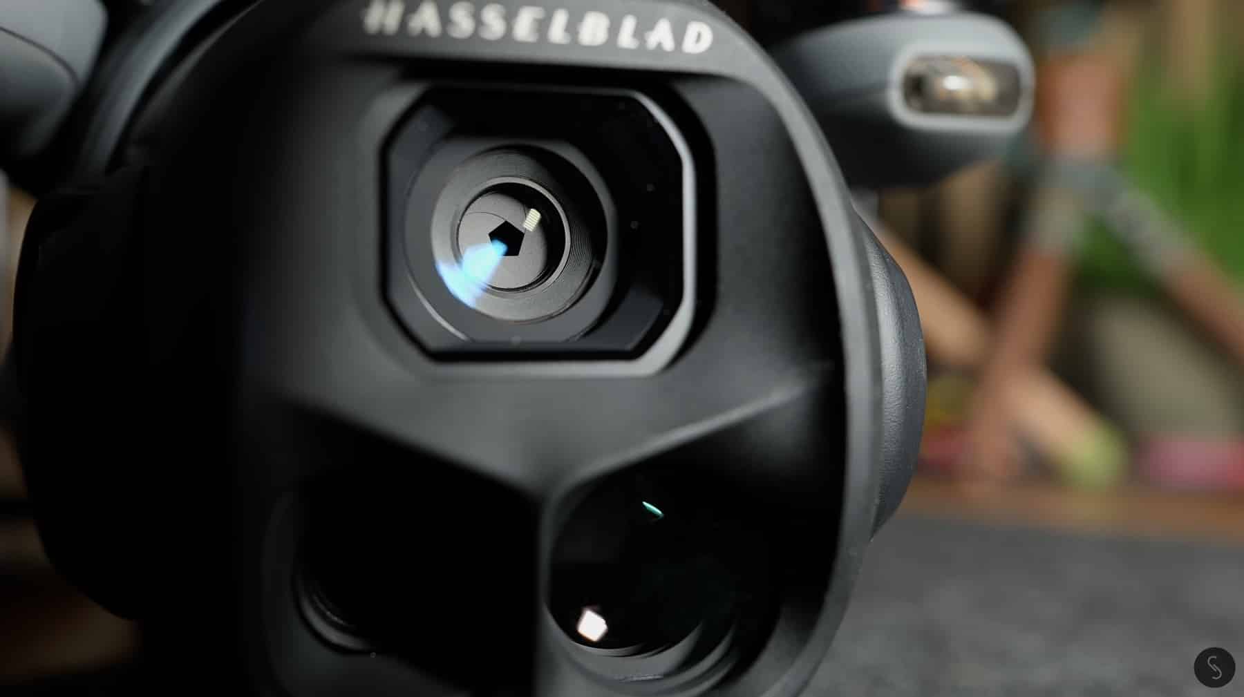 Extreme close-up of the Hasselblad-branded gimbal camera lens on the larger drone.