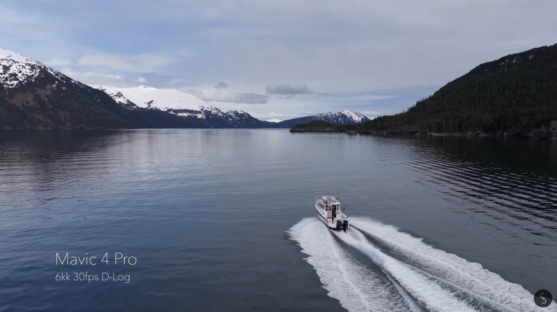 A small boat cuts a wake across a glacial lake in 6K D-Log.