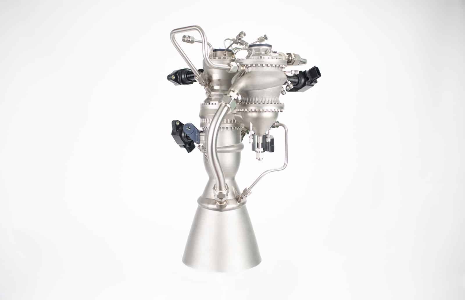 Polished rocket engine with its bell nozzle photographed on a white background.