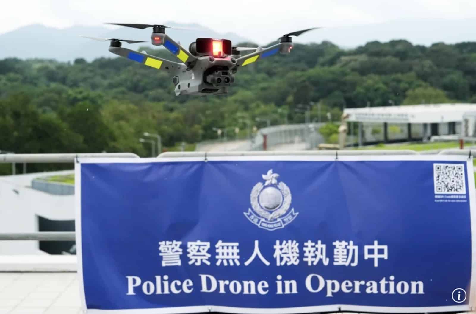 A police drone flies above a banner reading Police Drone in Operation.