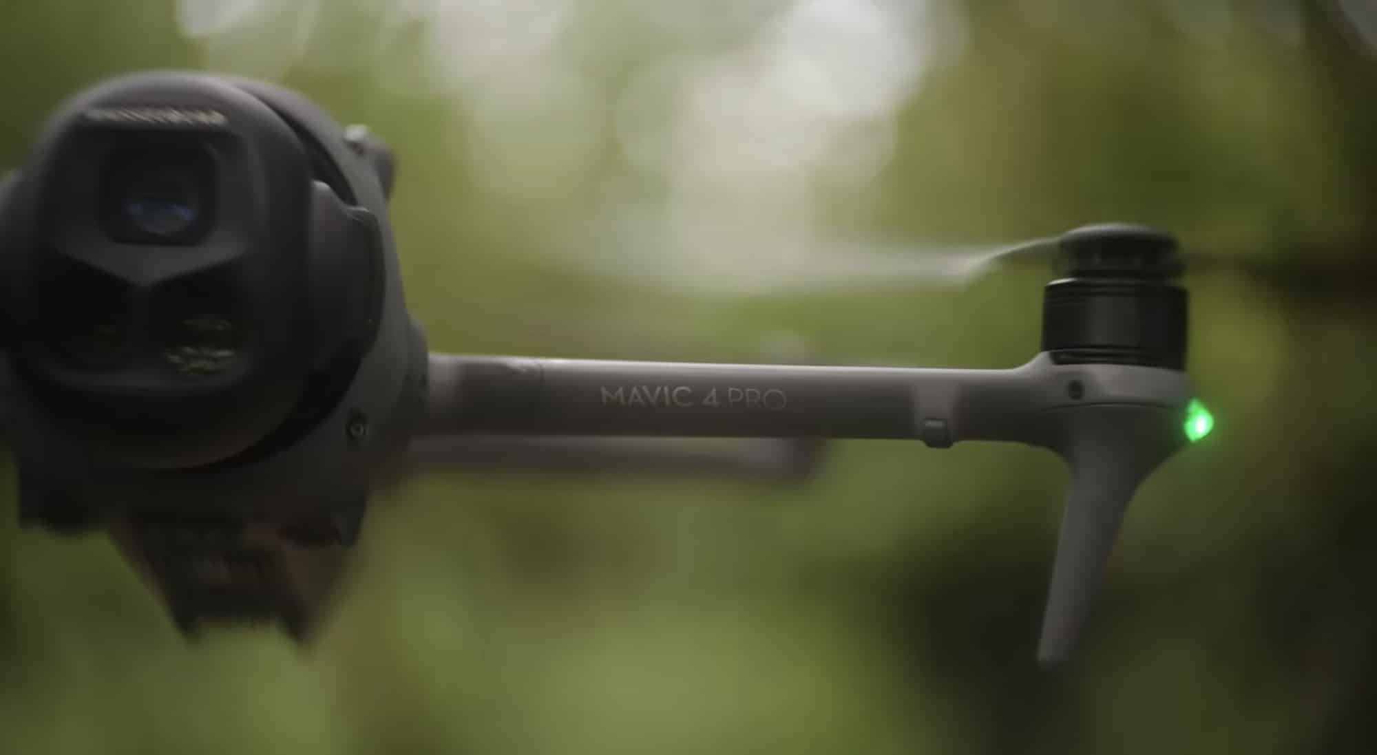 Close-up of the Mavic 4 Pro gimbal head and arm against blurred greenery.
