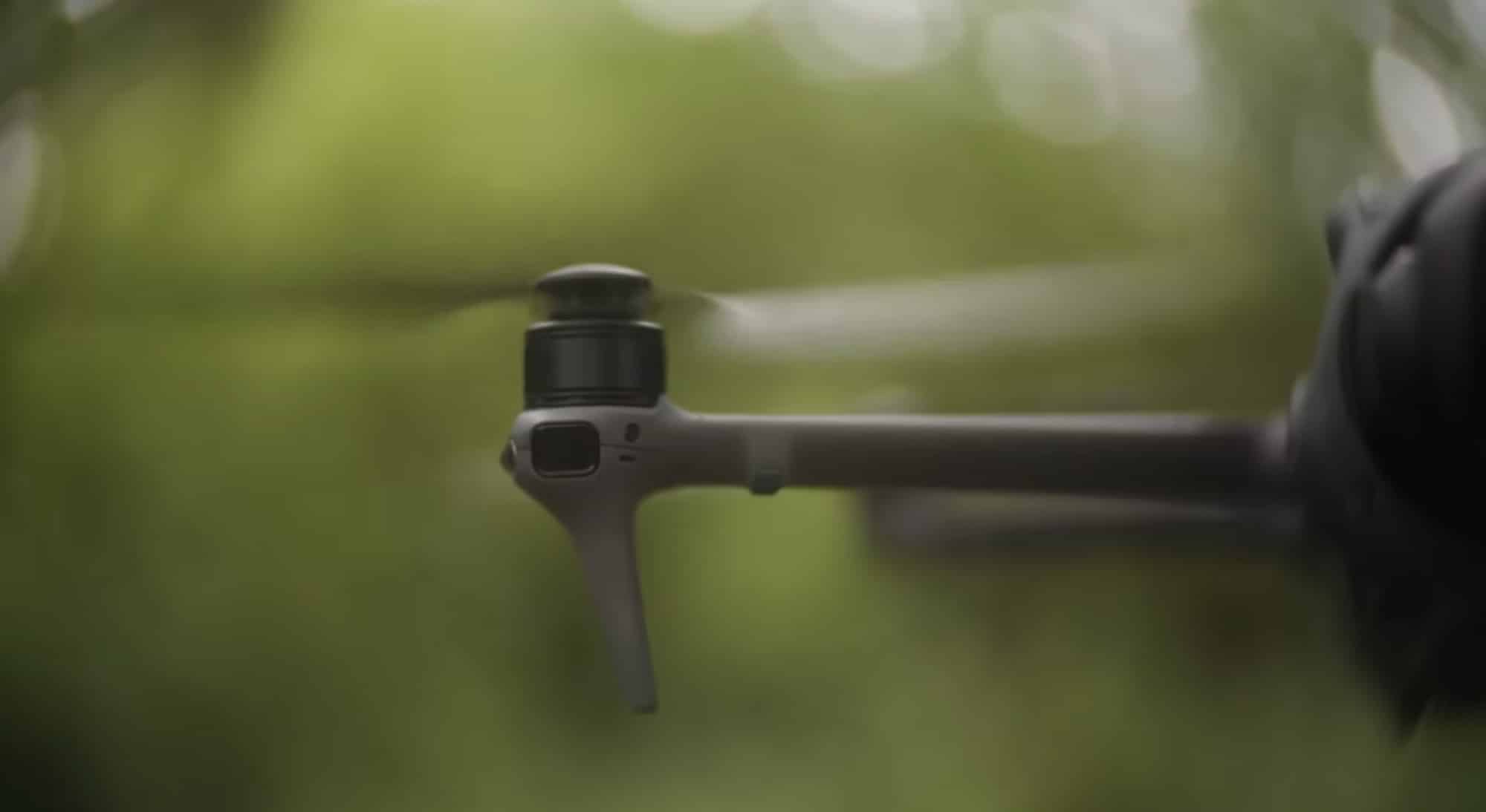 Side profile of the Mavic 4 Pro hovering with propellers spinning.