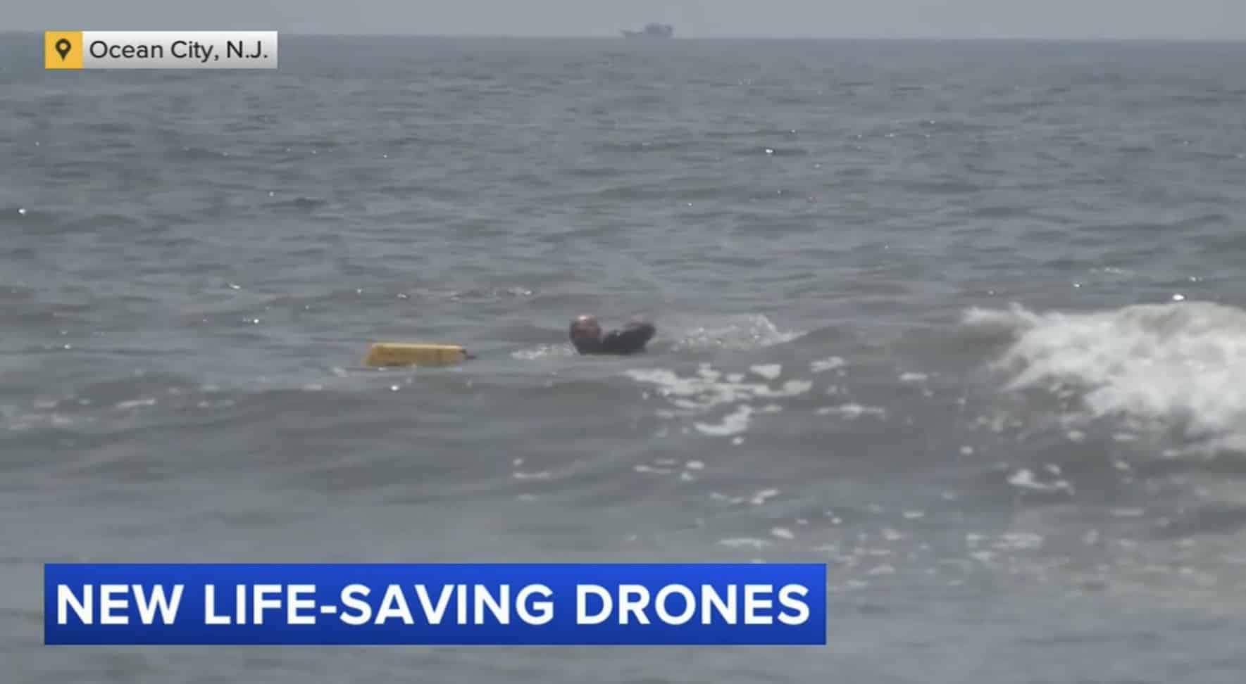 News frame of a swimmer beside a yellow flotation tube in the surf off Ocean City.