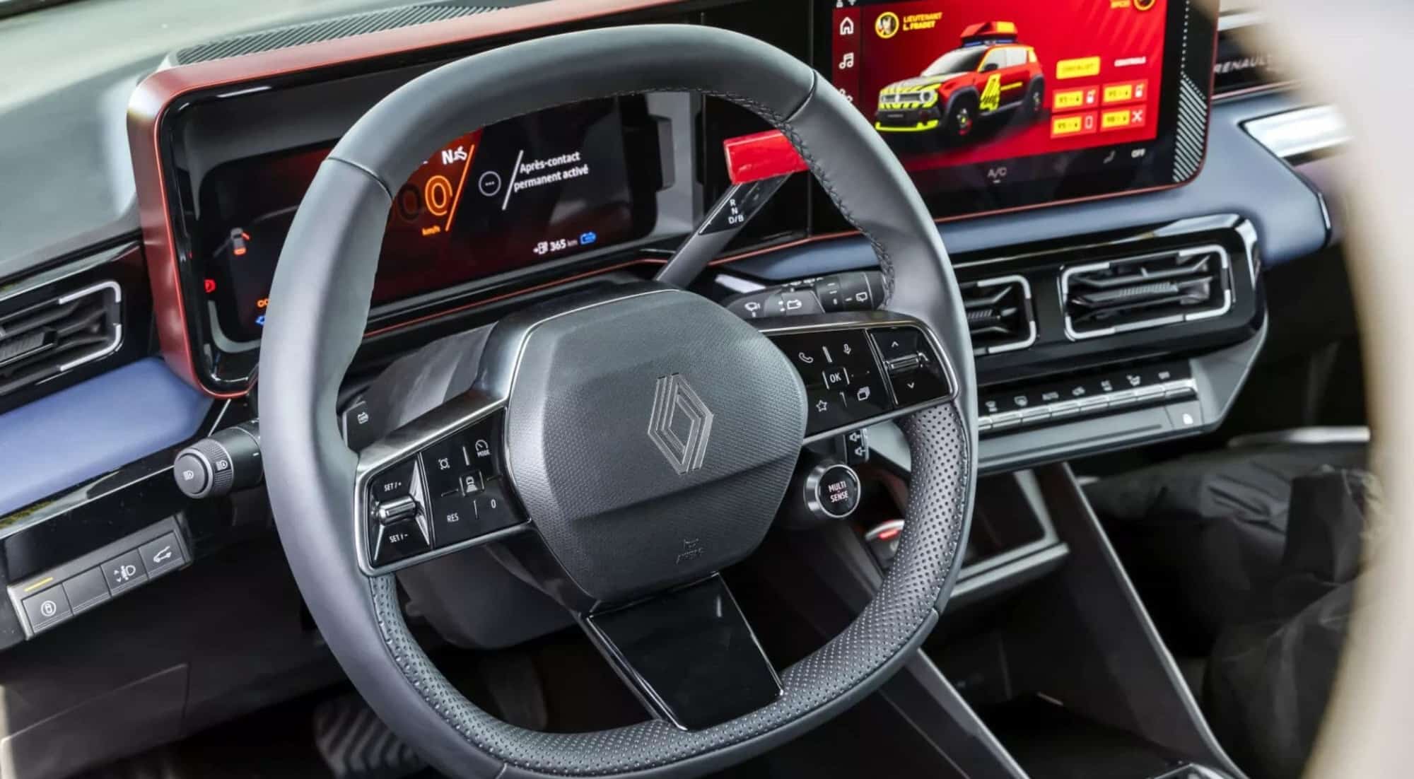 Interior view of the steering wheel and twin dashboard displays.