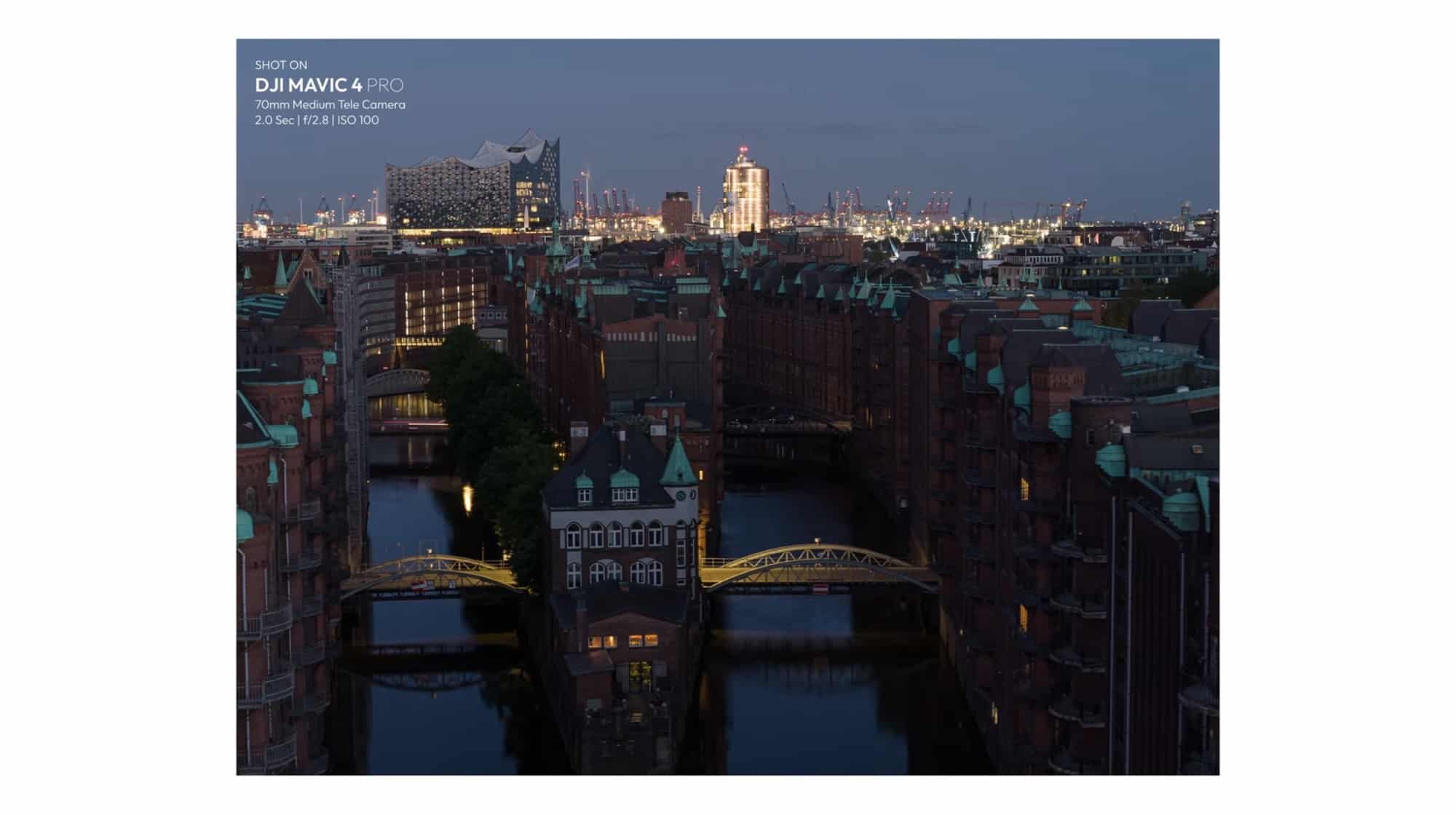 Speicherstadt warehouses and lit bridges at dusk through the 70mm medium tele camera.