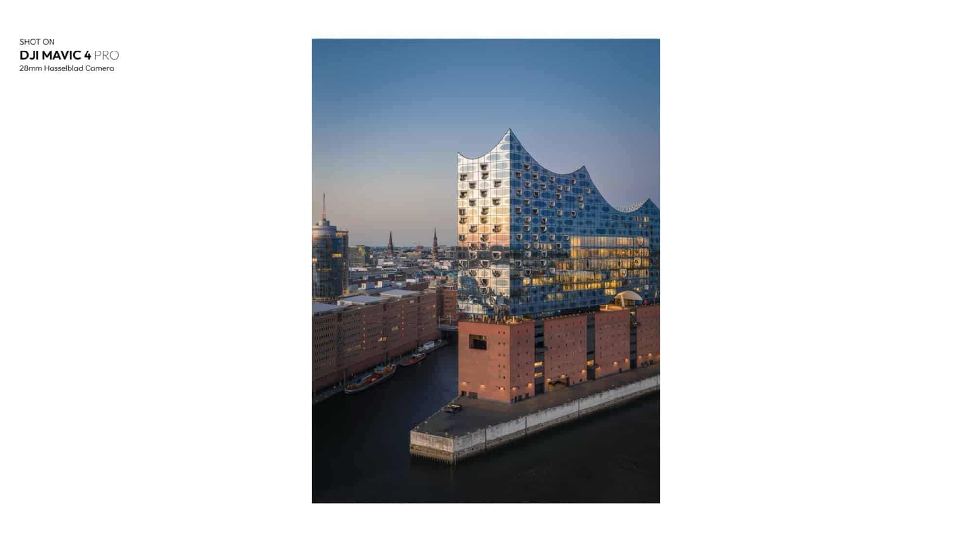 Vertical dusk aerial of the Elbphilharmonie above its brick warehouse base.