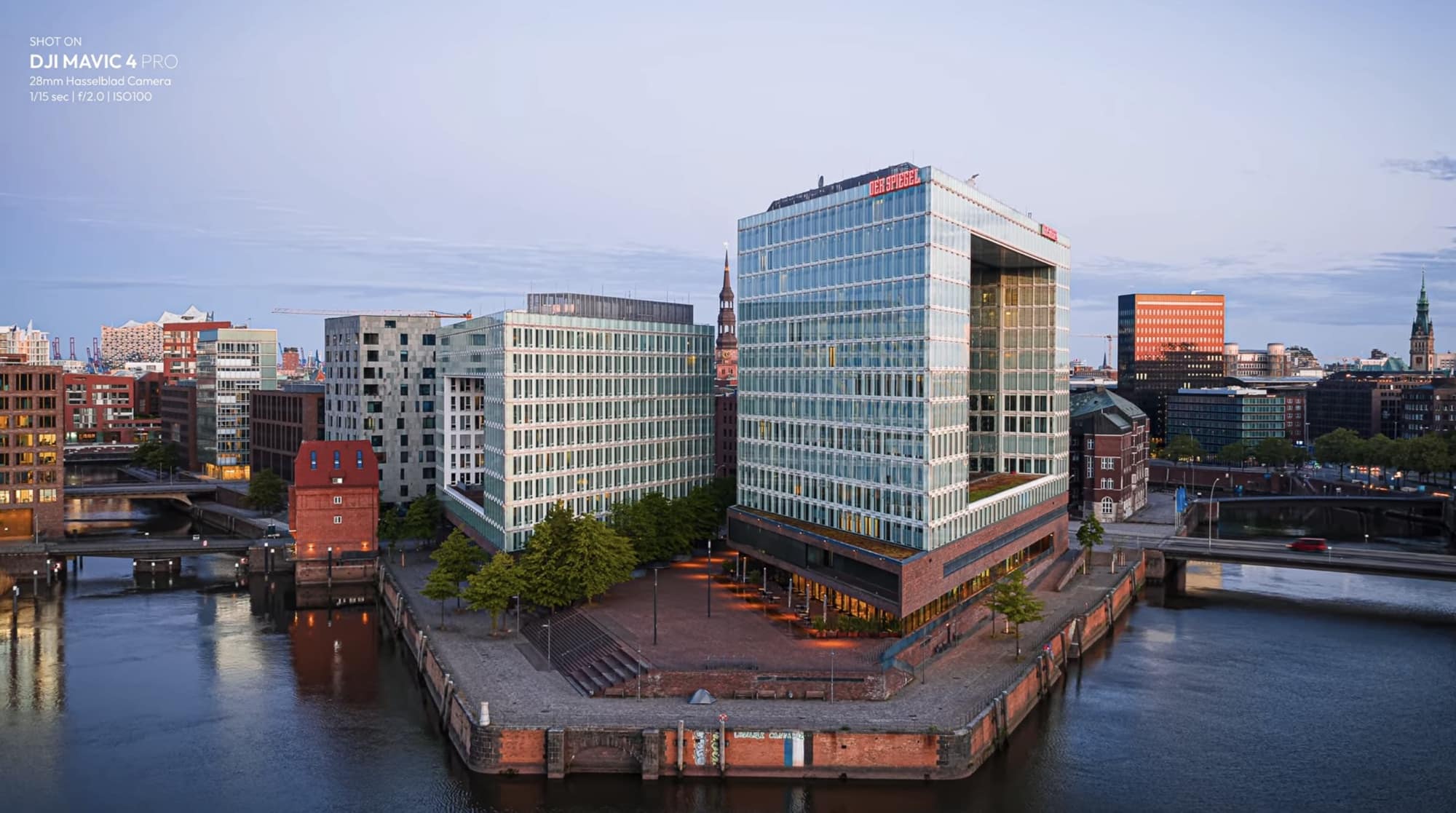 Glass office block on a harbor peninsula at blue hour, one tenth second at ISO 100.