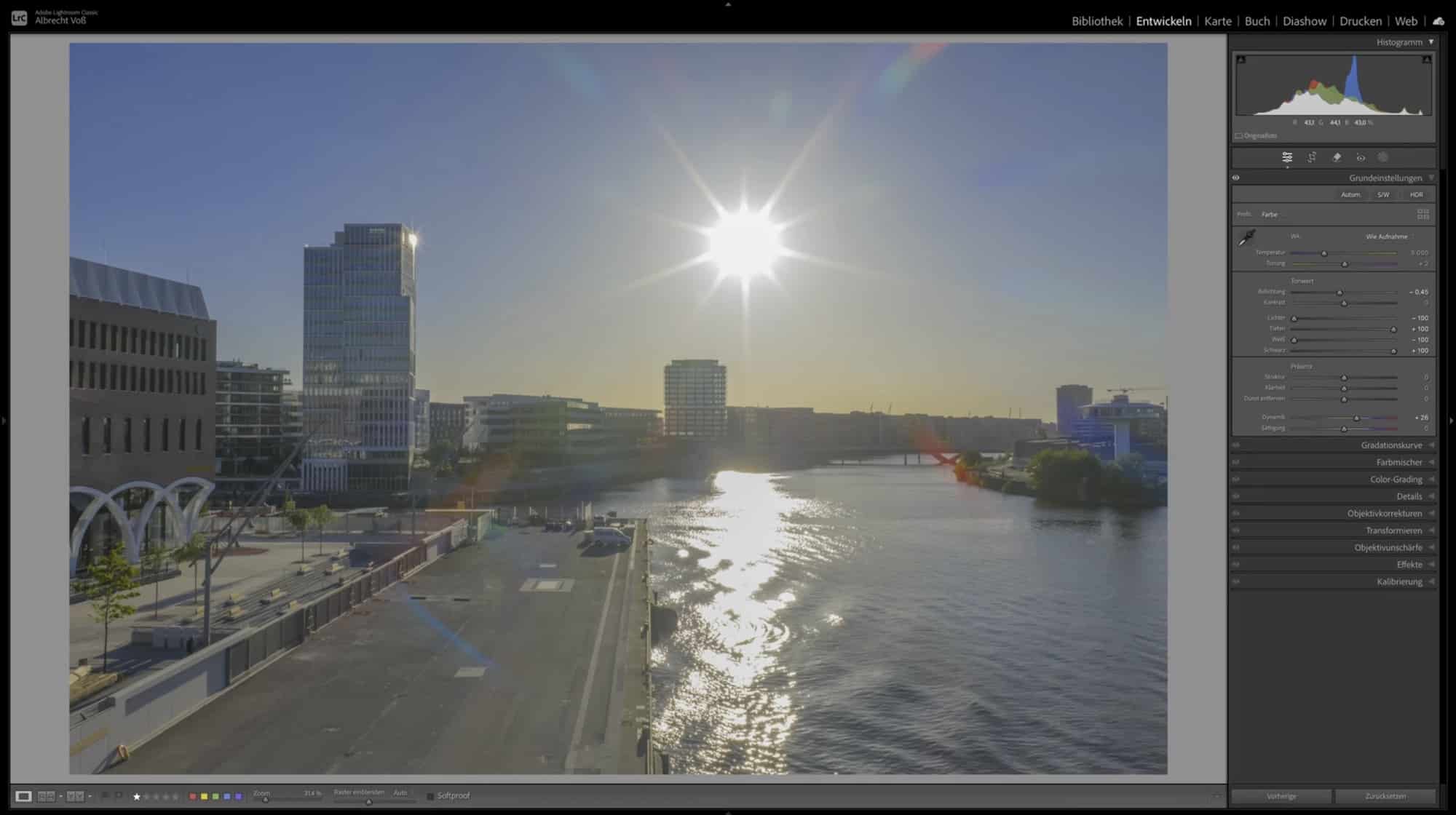 Lightroom develop module holding a backlit sunburst and flare over the Elbe.