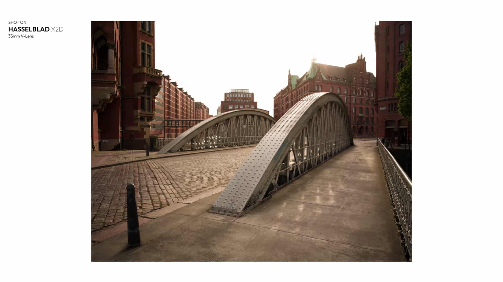 Ground-level Hasselblad X2D frame looking along the same arched bridge deck.