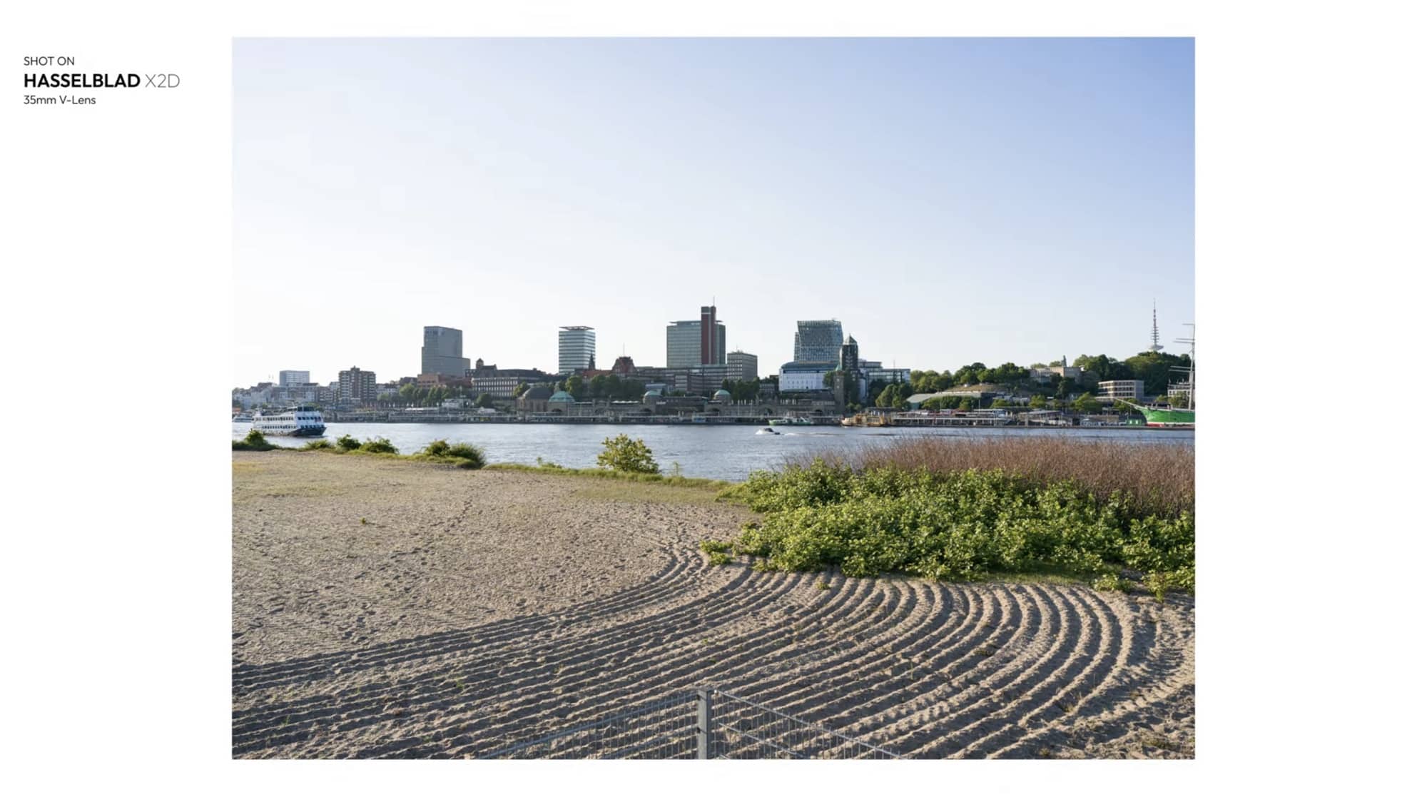 Hamburg skyline across the Elbe from a raked sand beach, shot on the X2D.