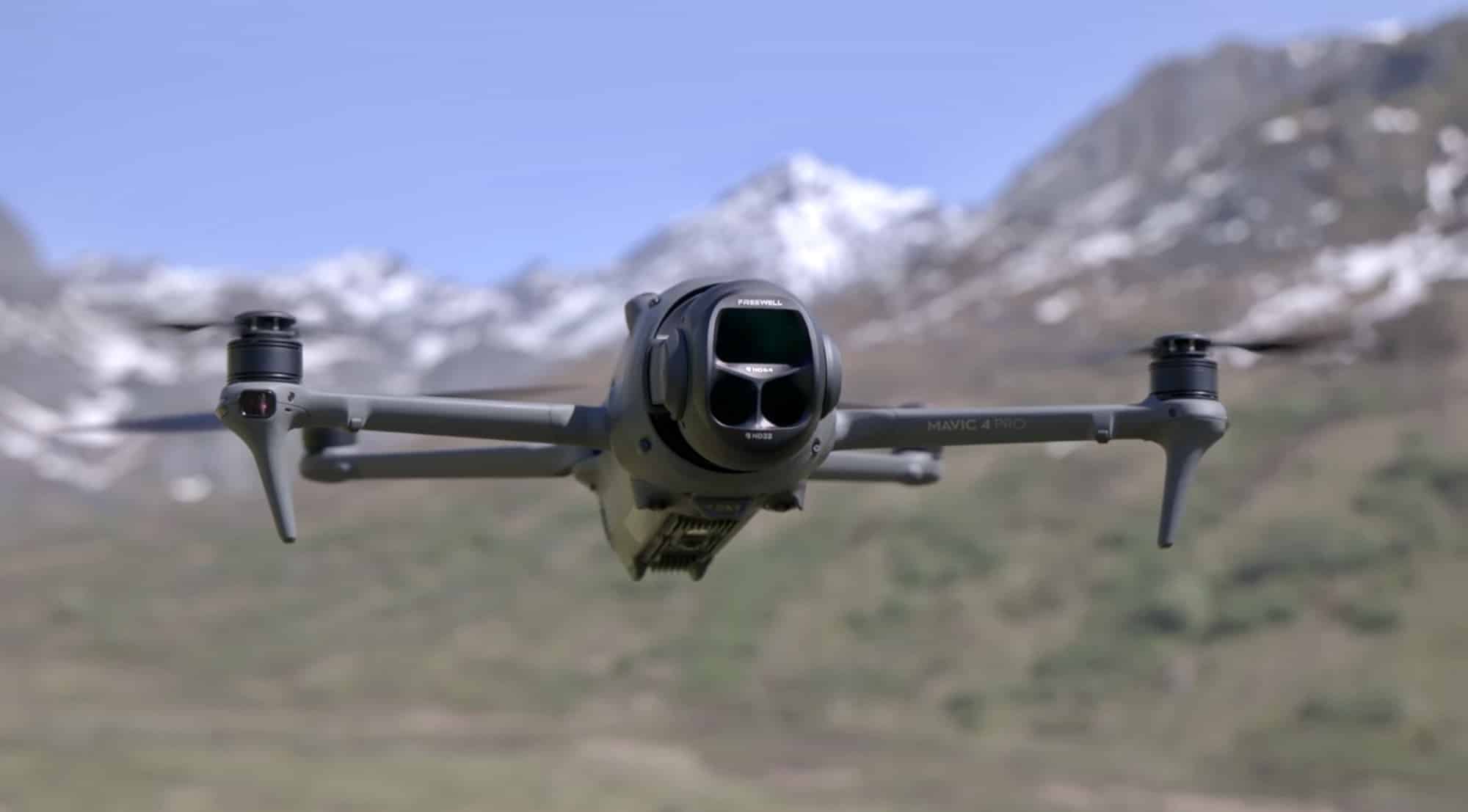 The Mavic 4 Pro hovers with a filter fitted, snowy peaks blurred behind.