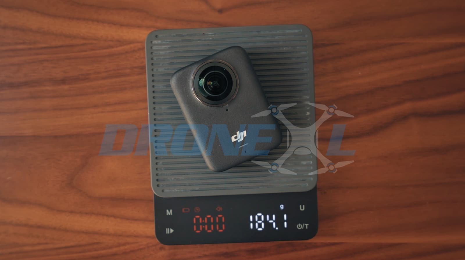 DJI Osmo 360 square body with dual 180-degree fisheye lenses front and back.