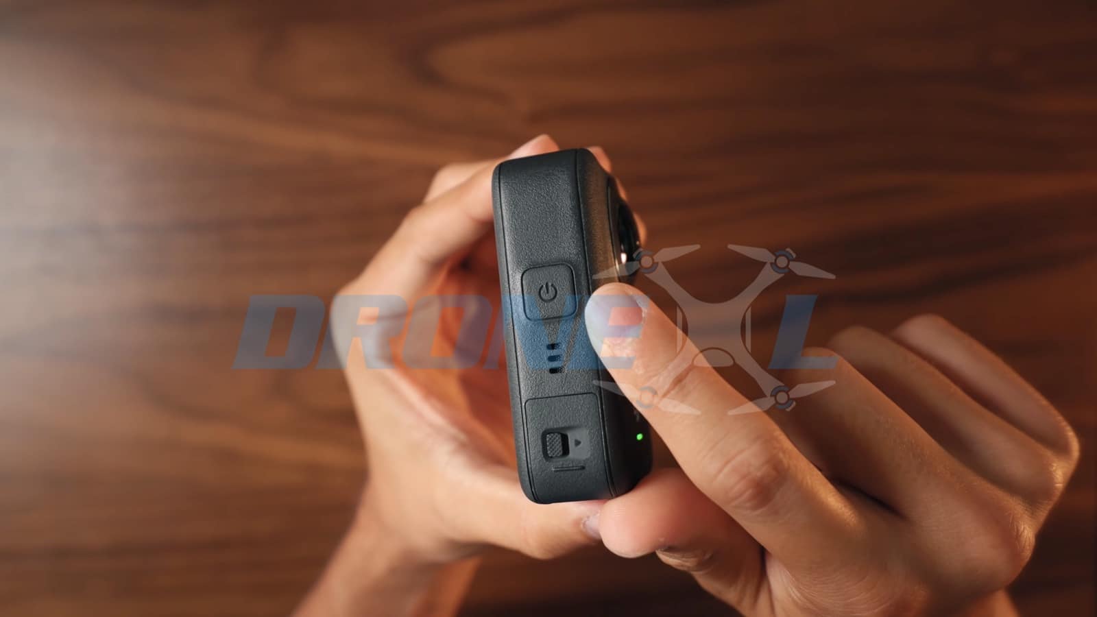 Side profile of the camera showing the power button and battery status lights.