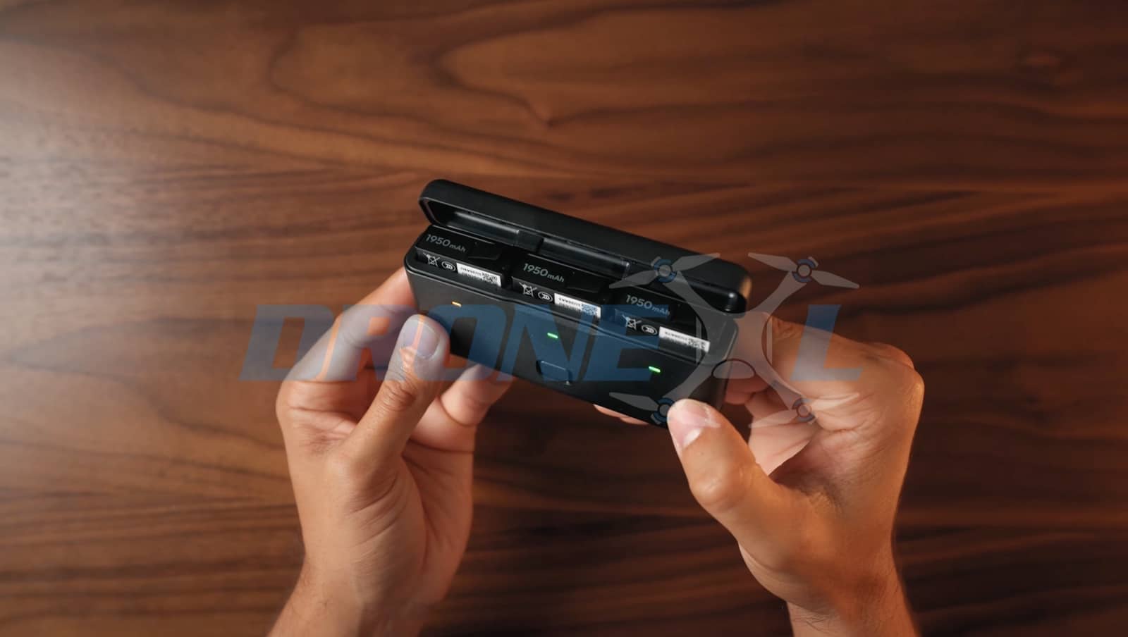 Hands opening the base compartment door to reach the removable battery.