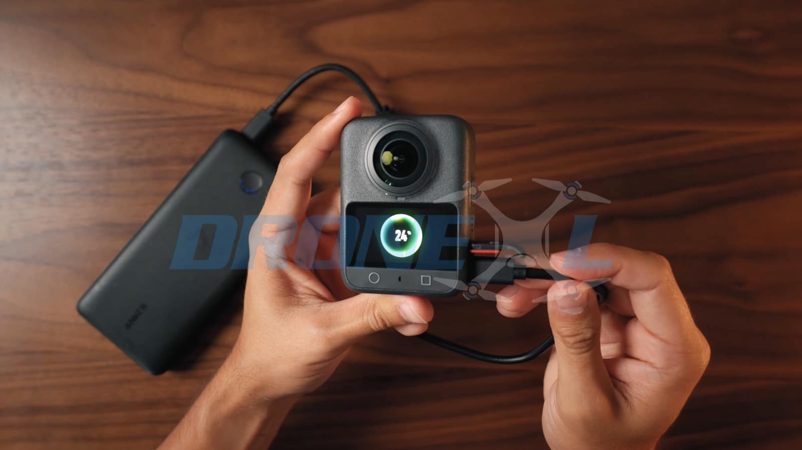 Charging ring at 24 percent on the screen while the camera draws from a power bank.