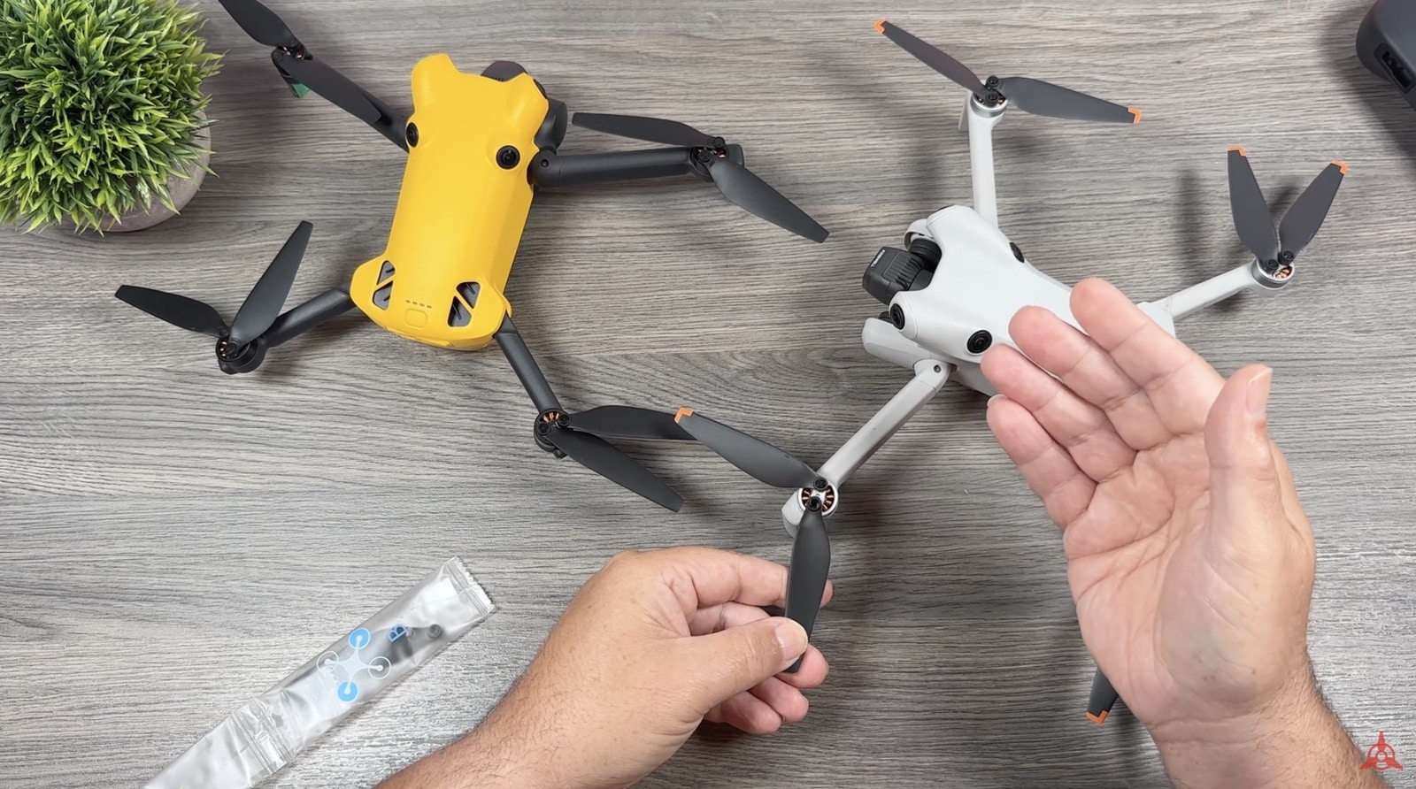 SkyRover X1 and a gray DJI Mini laid side by side for comparison.