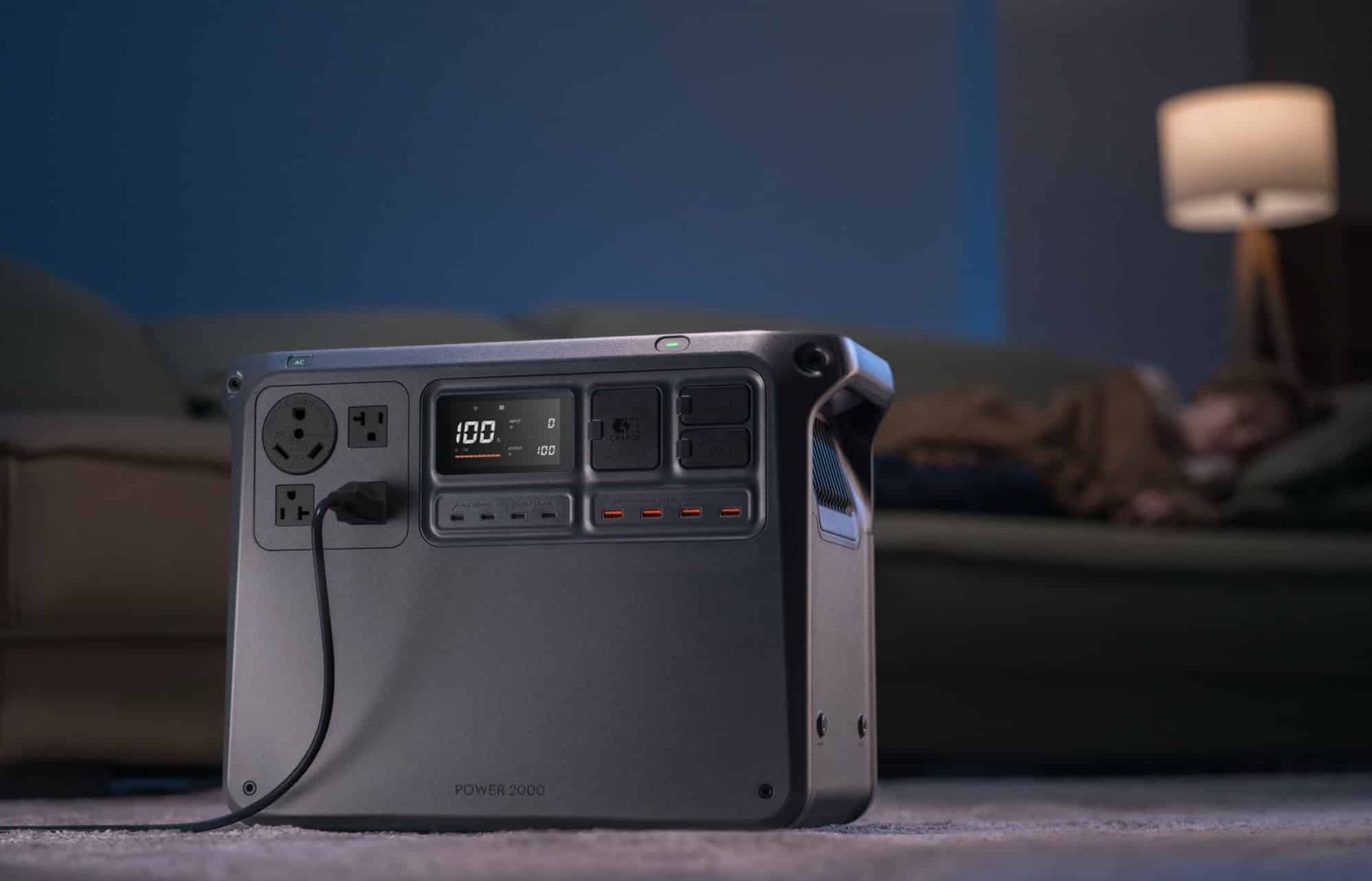 The power station sits on a living room floor with its display lit.