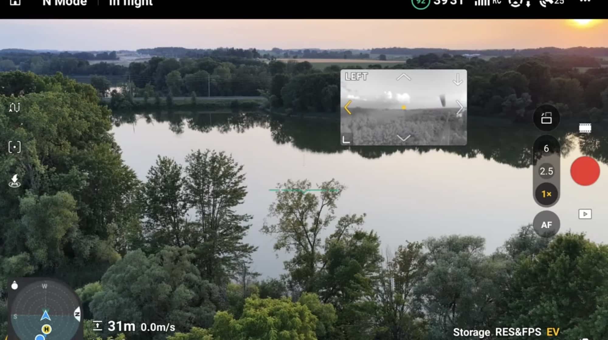In-flight app view over a wooded lake with the vision assist window floating.