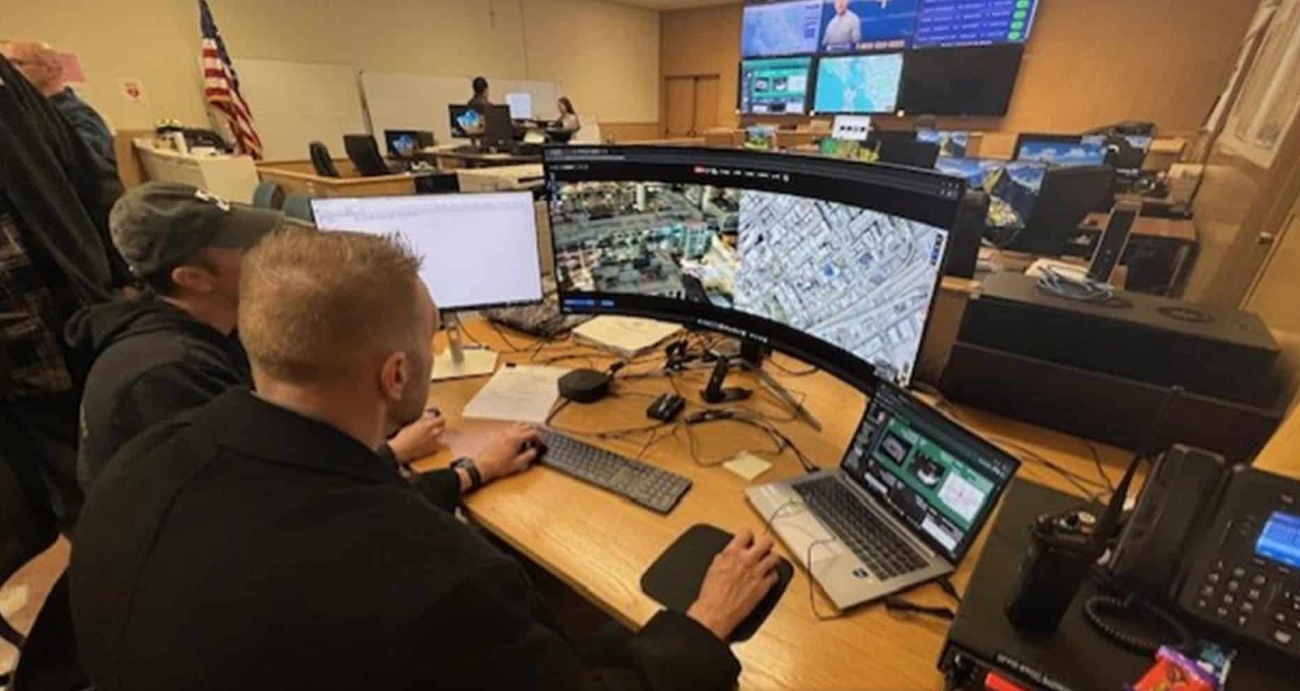 Deputies work banks of monitors and a curved mapping display in the operations centre.