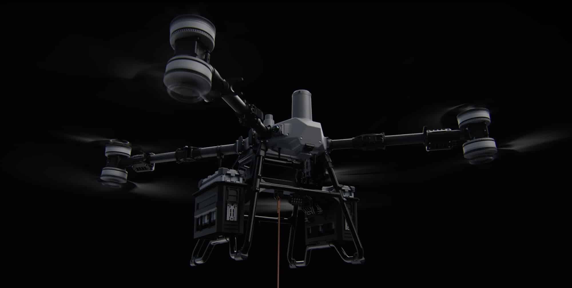 Studio shot of the Agras T100 on black with its eight rotors spinning.