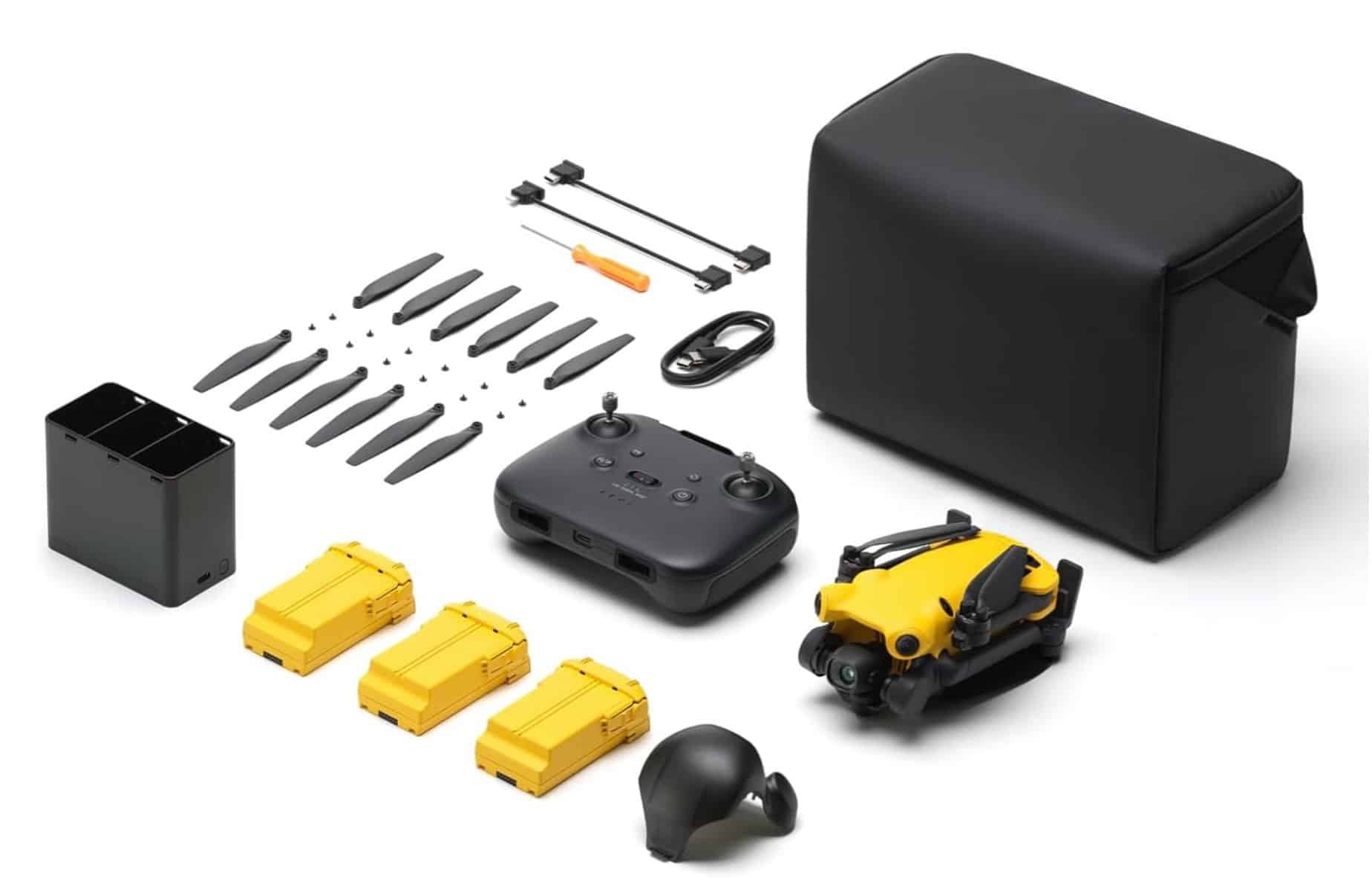 Flat-lay of the yellow SkyRover X1 kit with controller, three batteries, props and bag.