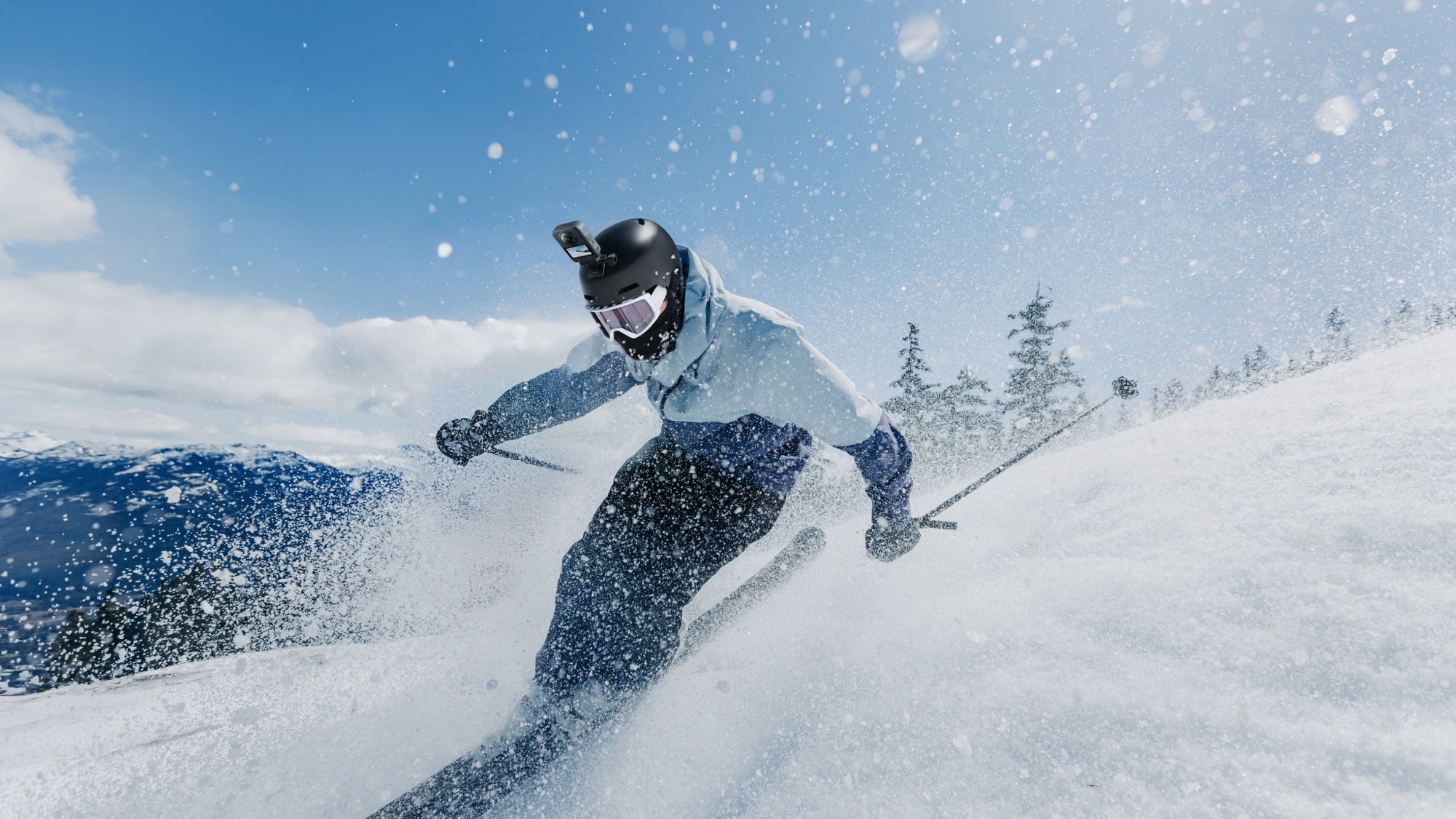 Low angle of a skier throwing snow spray, a camera boom rising from the helmet.