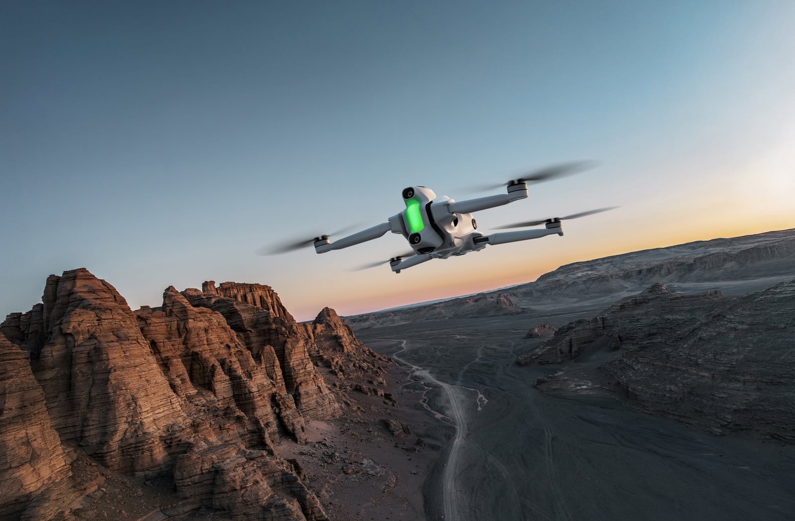 The Antigravity A1 drone in profile with its top and bottom 360-degree lenses visible.