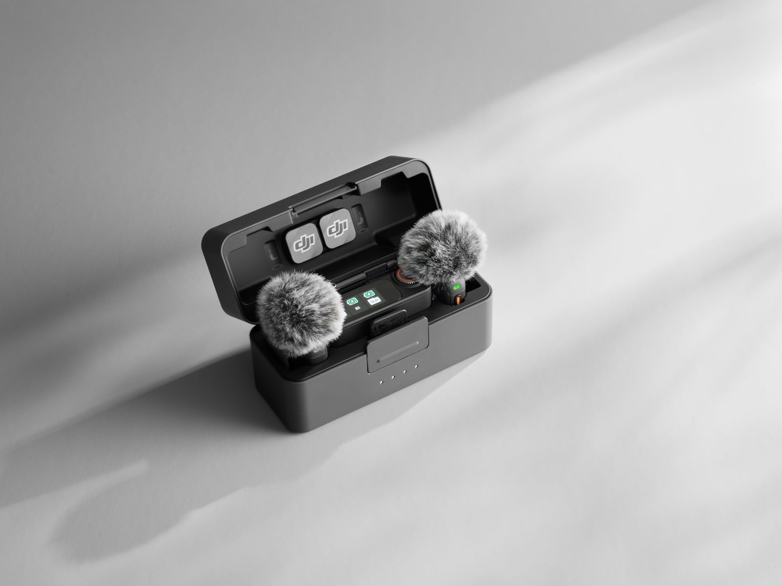 The DJI Mic 3 charging case holding two transmitters and one receiver.