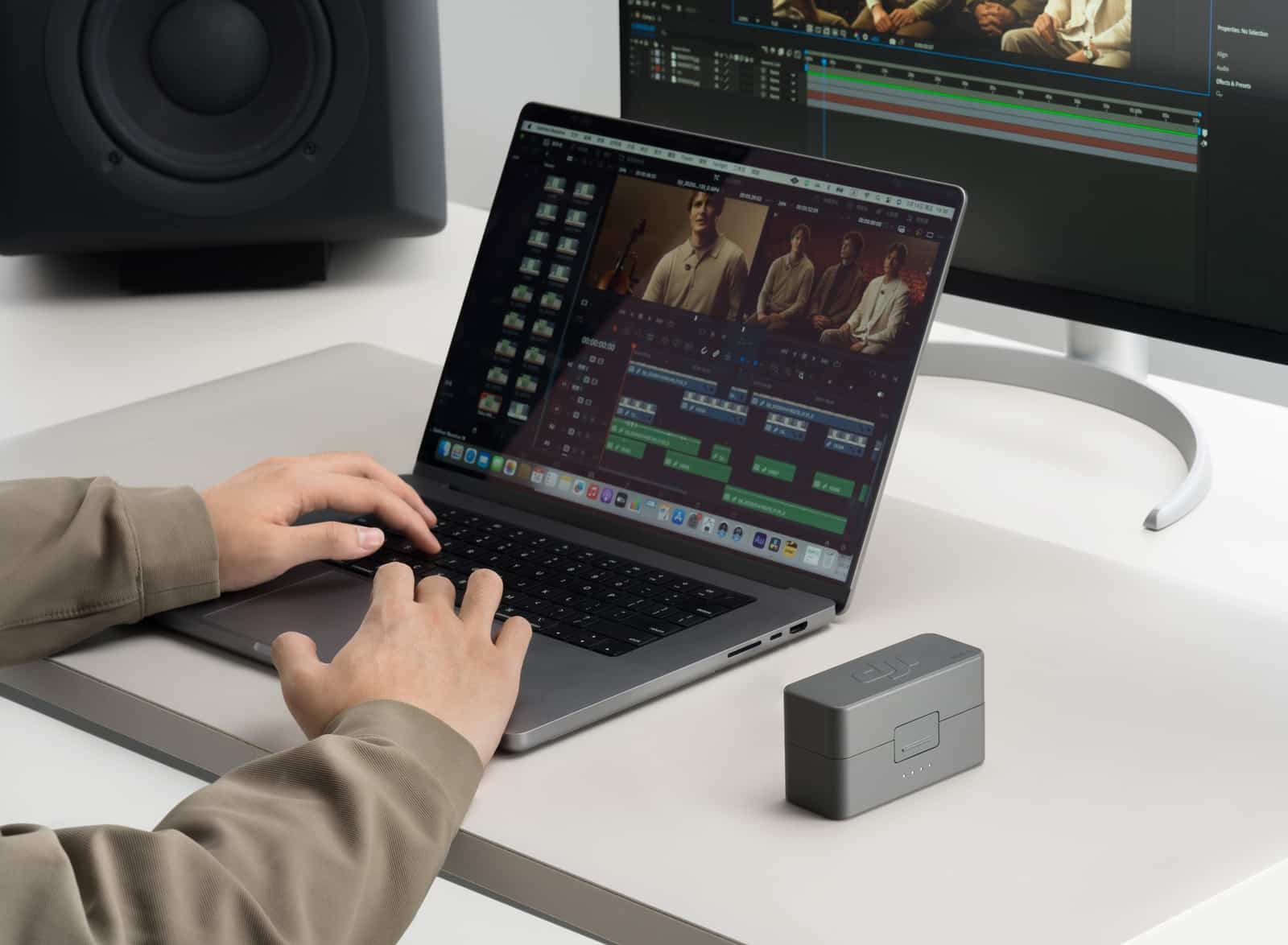 Editor works in a video timeline on a laptop with an external display.