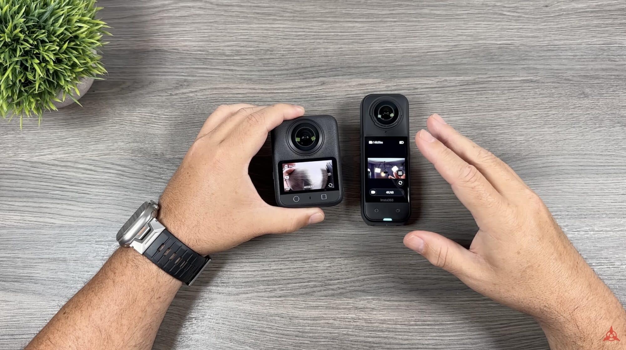 Hands hold the DJI Osmo 360 and Insta360 X5 side by side for comparison.