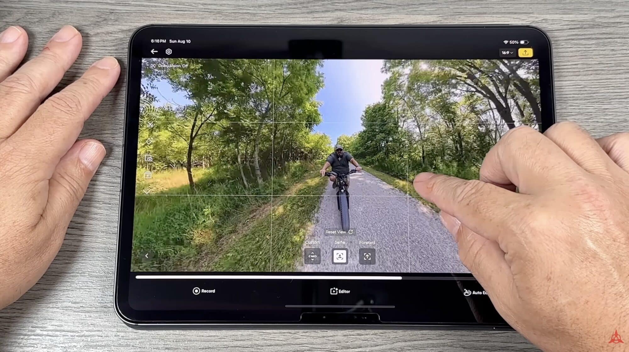 Reframing a cyclist clip in the DJI Mimo app on a tablet.