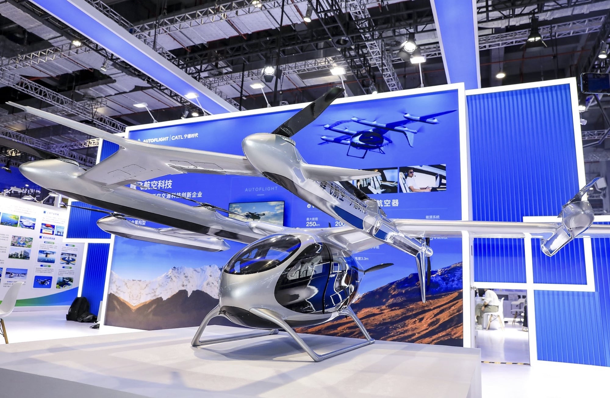 Tiltrotor electric aircraft on a blue exhibition stand at the Shanghai expo.