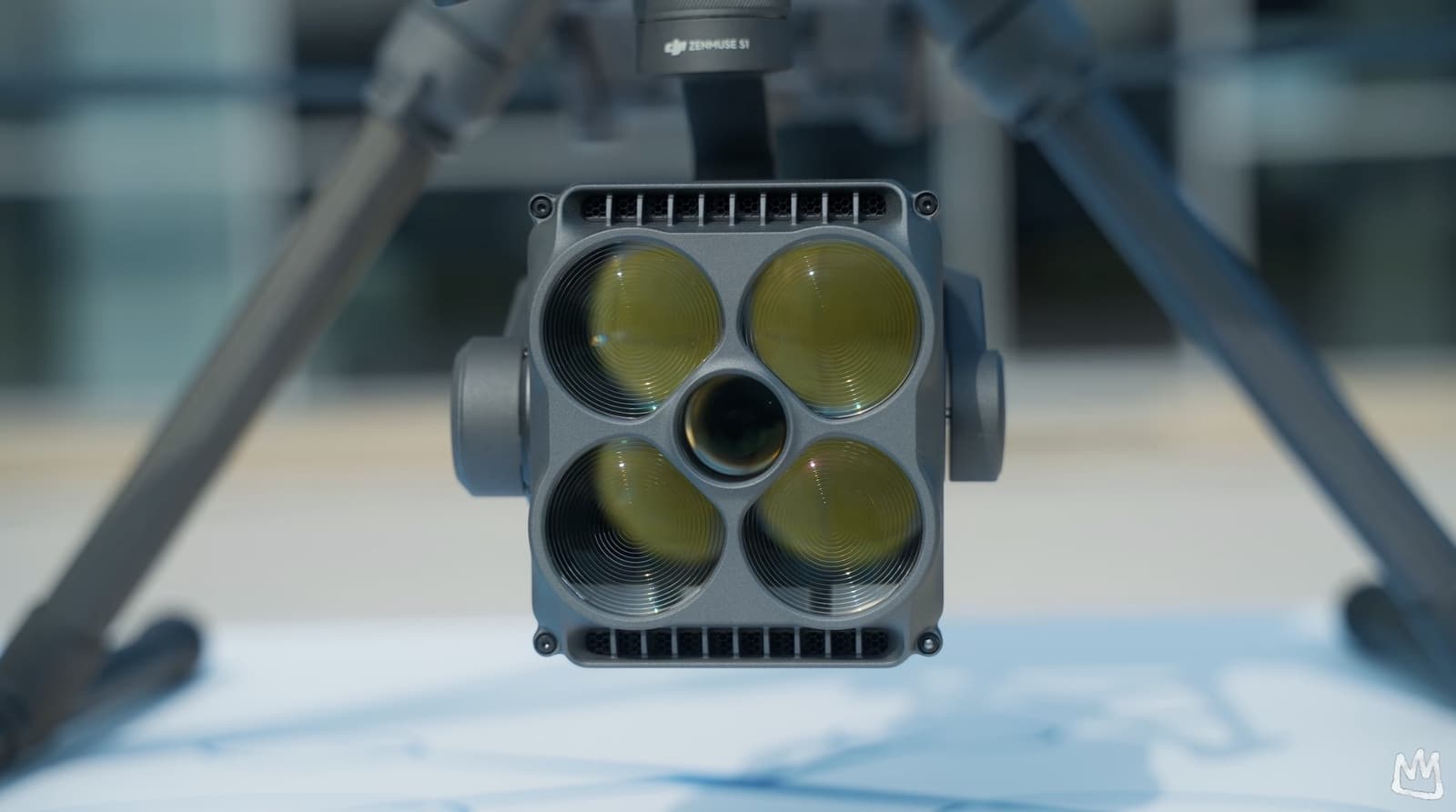 Close-up of a four-lens sensor payload mounted under the Matrice 400 airframe.