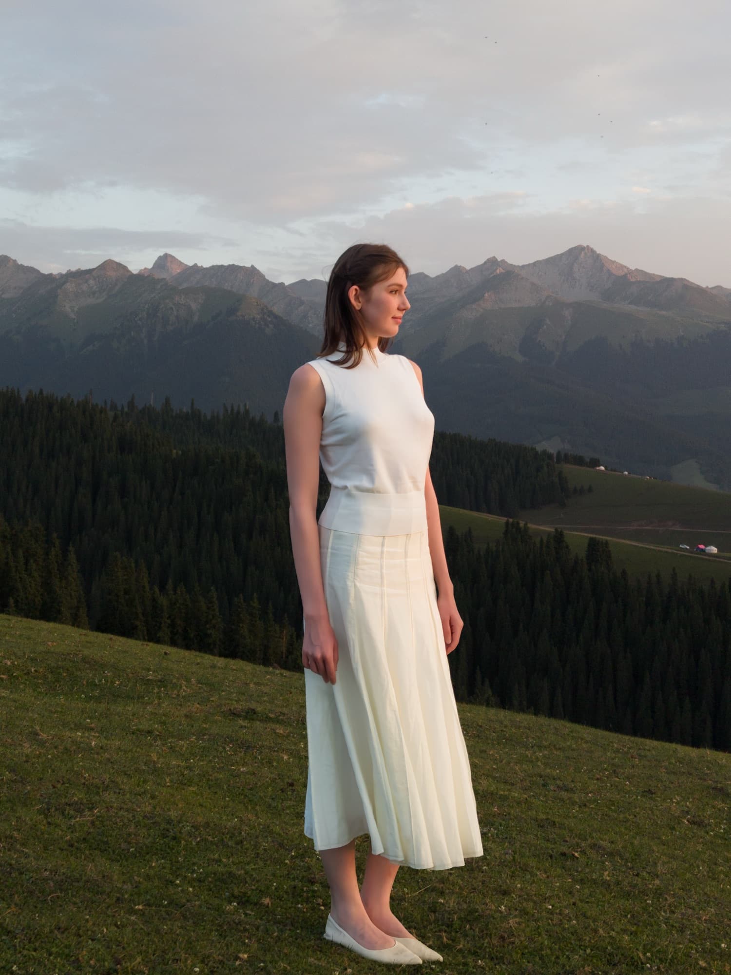 The same hillside portrait at two-times zoom, cropping tighter on the woman and ridgeline.