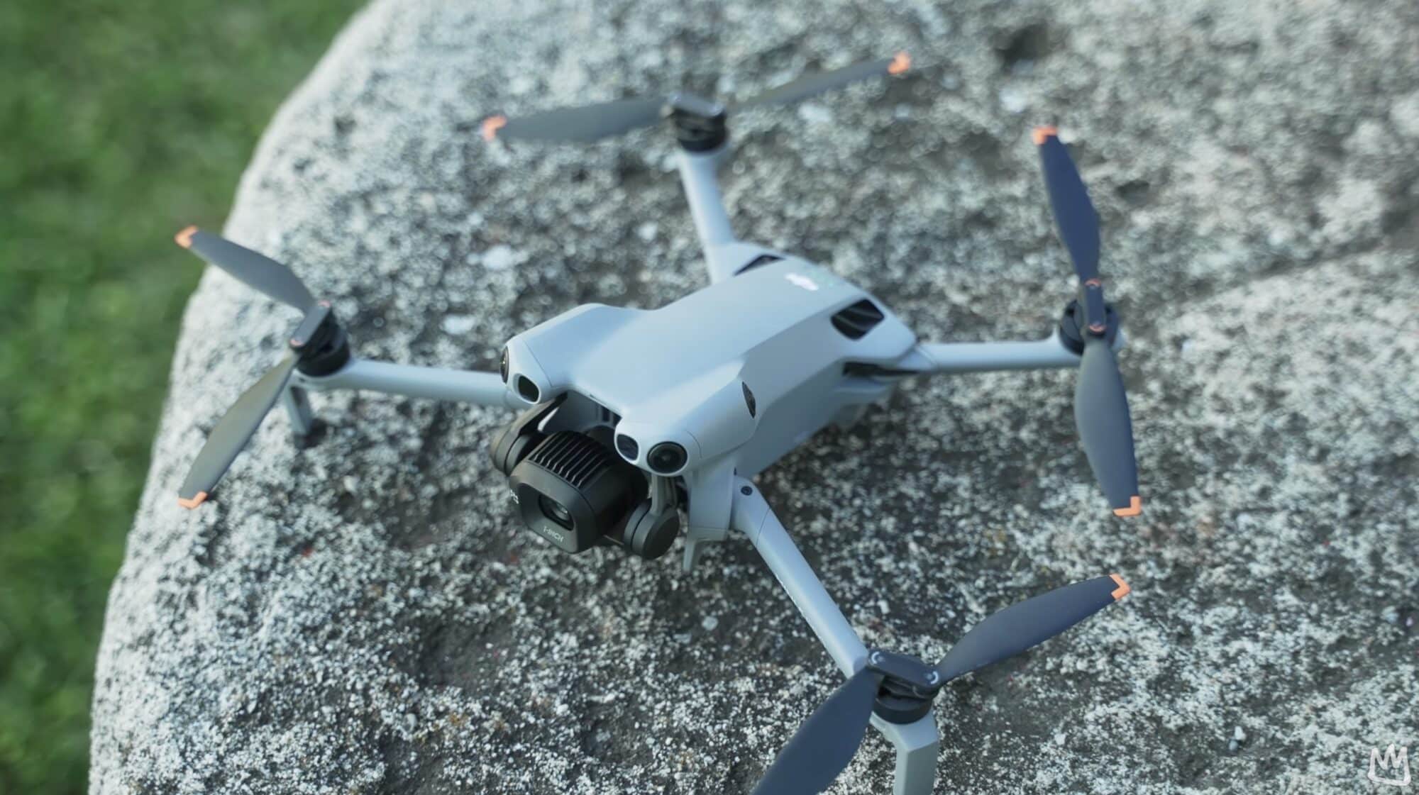 Unfolded Mini drone perched on a speckled granite boulder, seen from above.