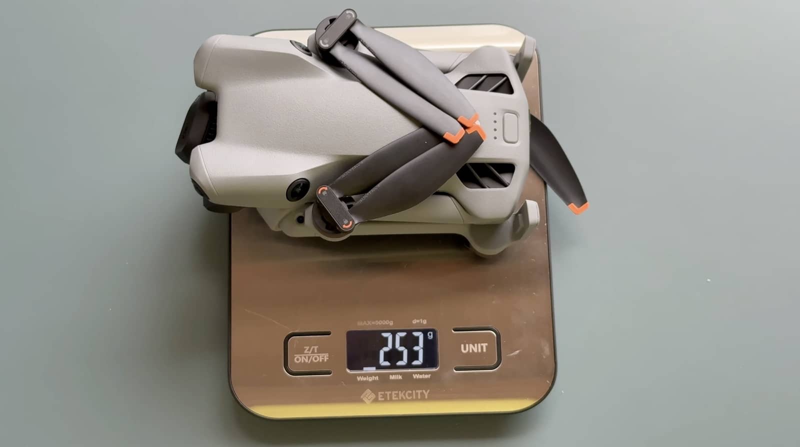 DJI Mini 5 Pro resting on an Etekcity scale that displays 253 grams.