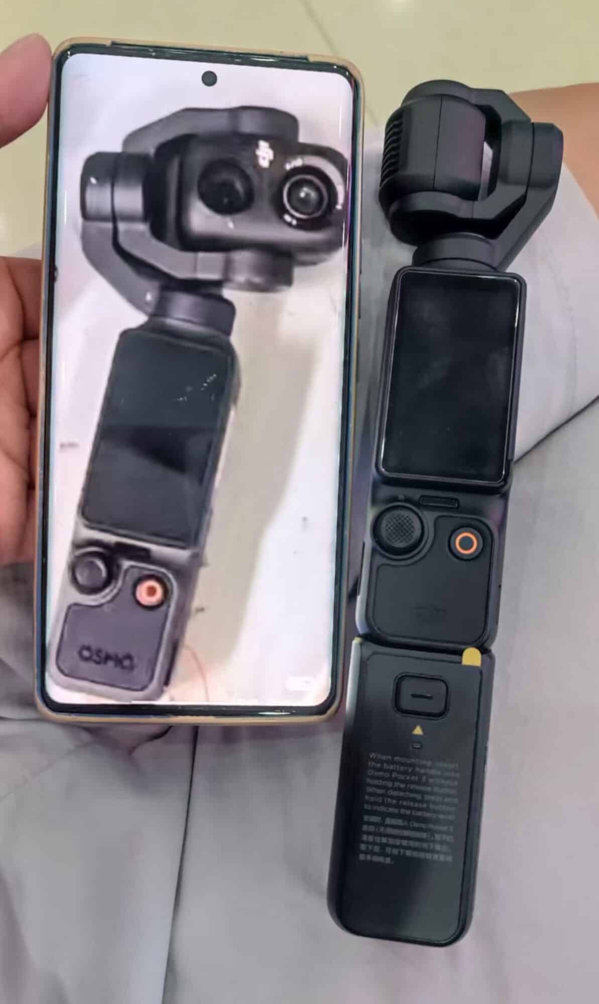 Leaked dual-lens pocket gimbal held beside a current Osmo Pocket 3 for comparison.