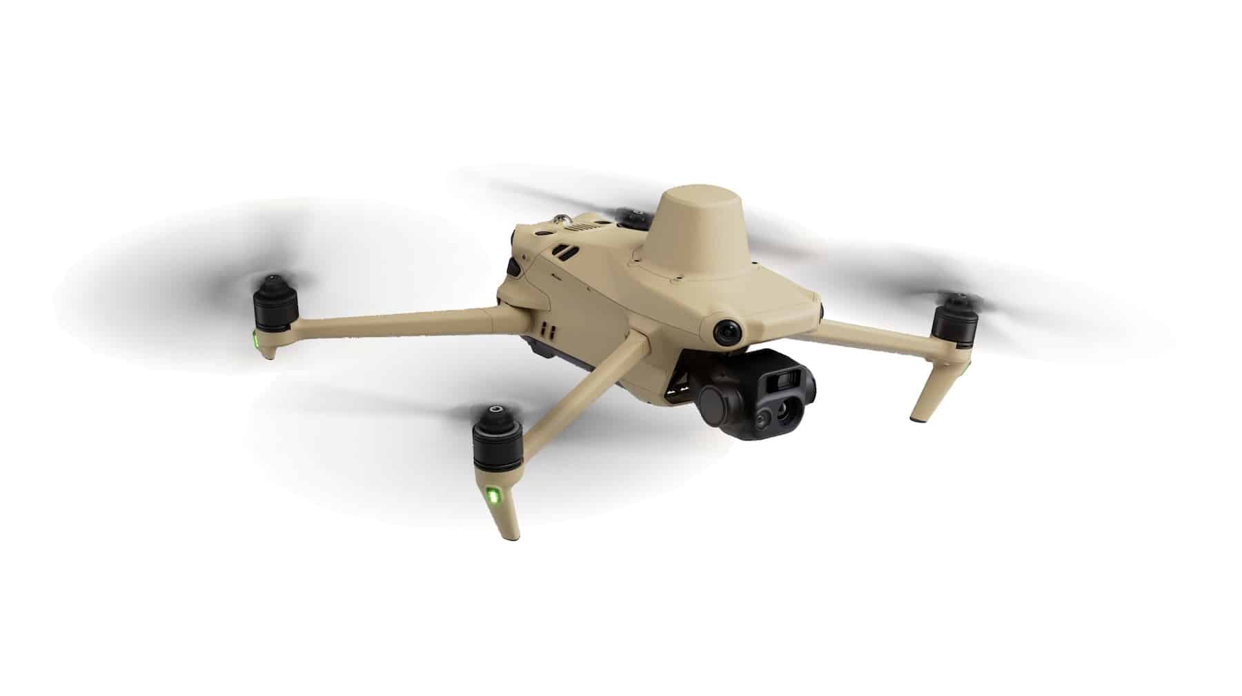 Tan enterprise quadcopter with a gimbal camera hovering against a white backdrop.