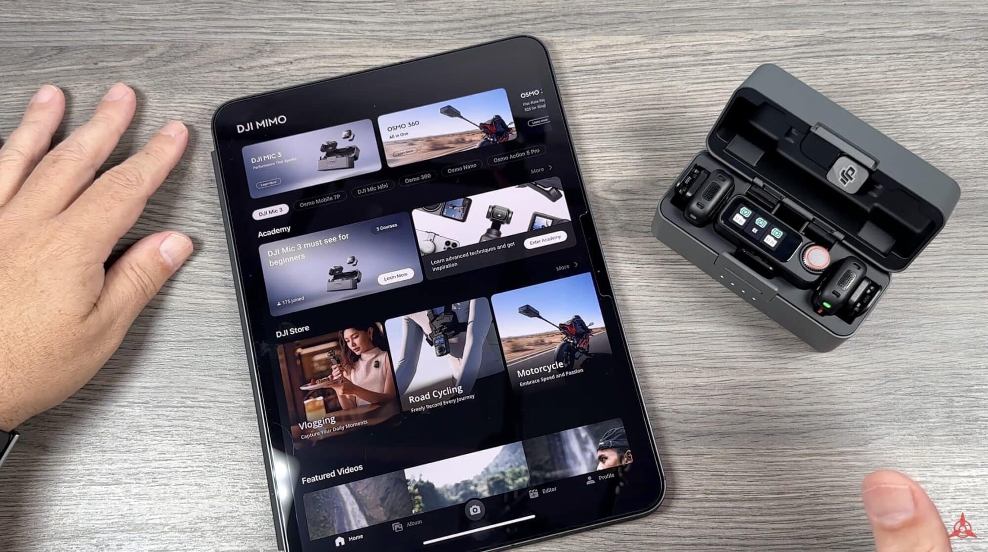 Tablet running the DJI Mimo app beside an open DJI Mic charging case.
