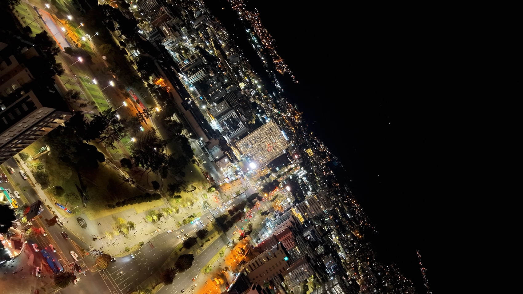 Rotated aerial night view of a lit city captured with a tilted gimbal.